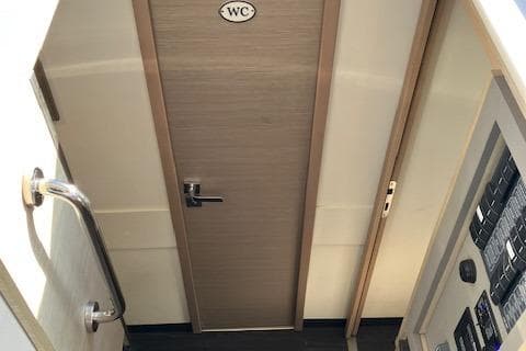 Interior view of 2021 Fountaine Pajot Isla 40 yacht, featuring a WC door and control panel.