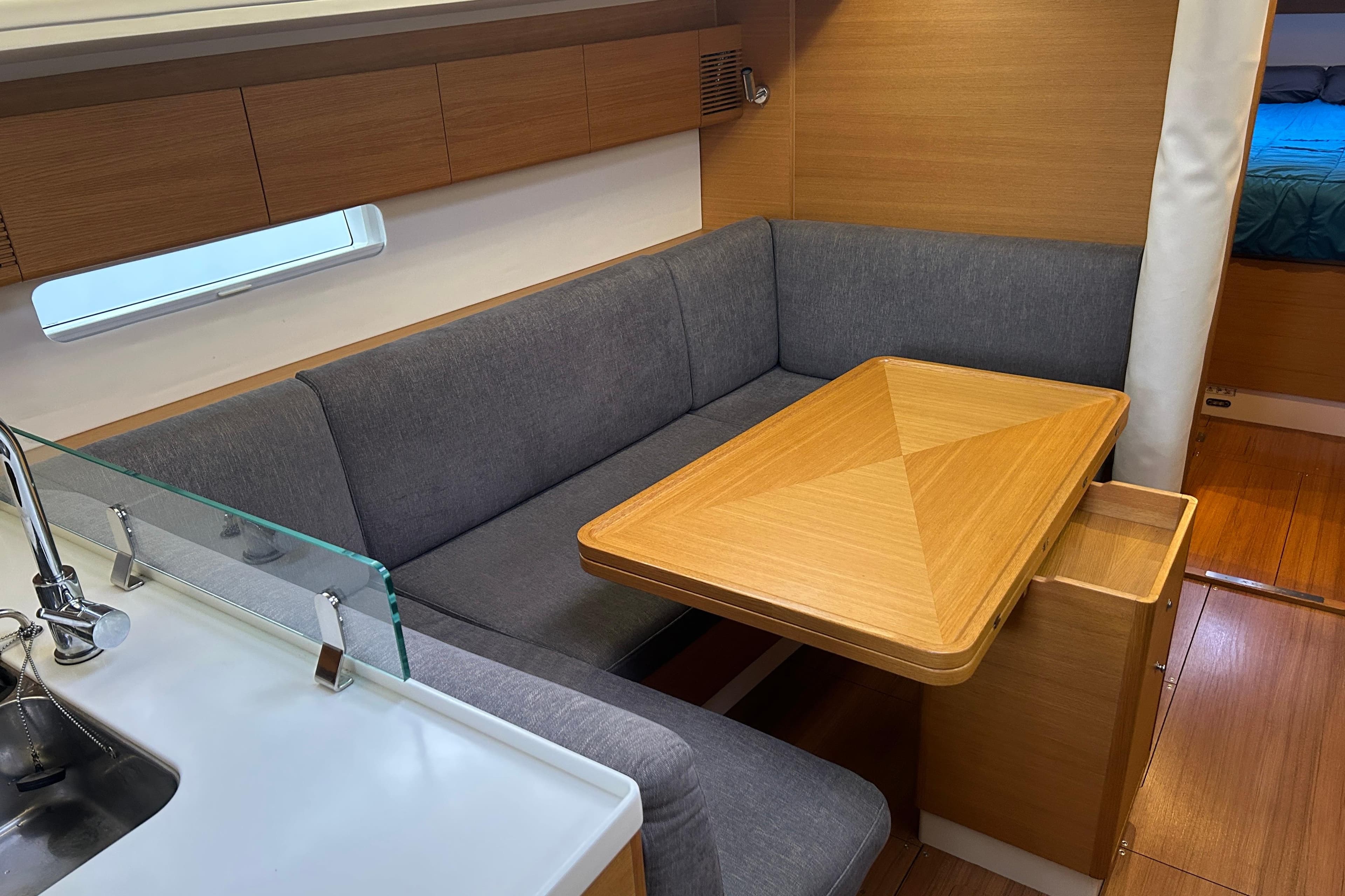 2019 X-Yachts X4³ interior with modern dining area and wooden table.
