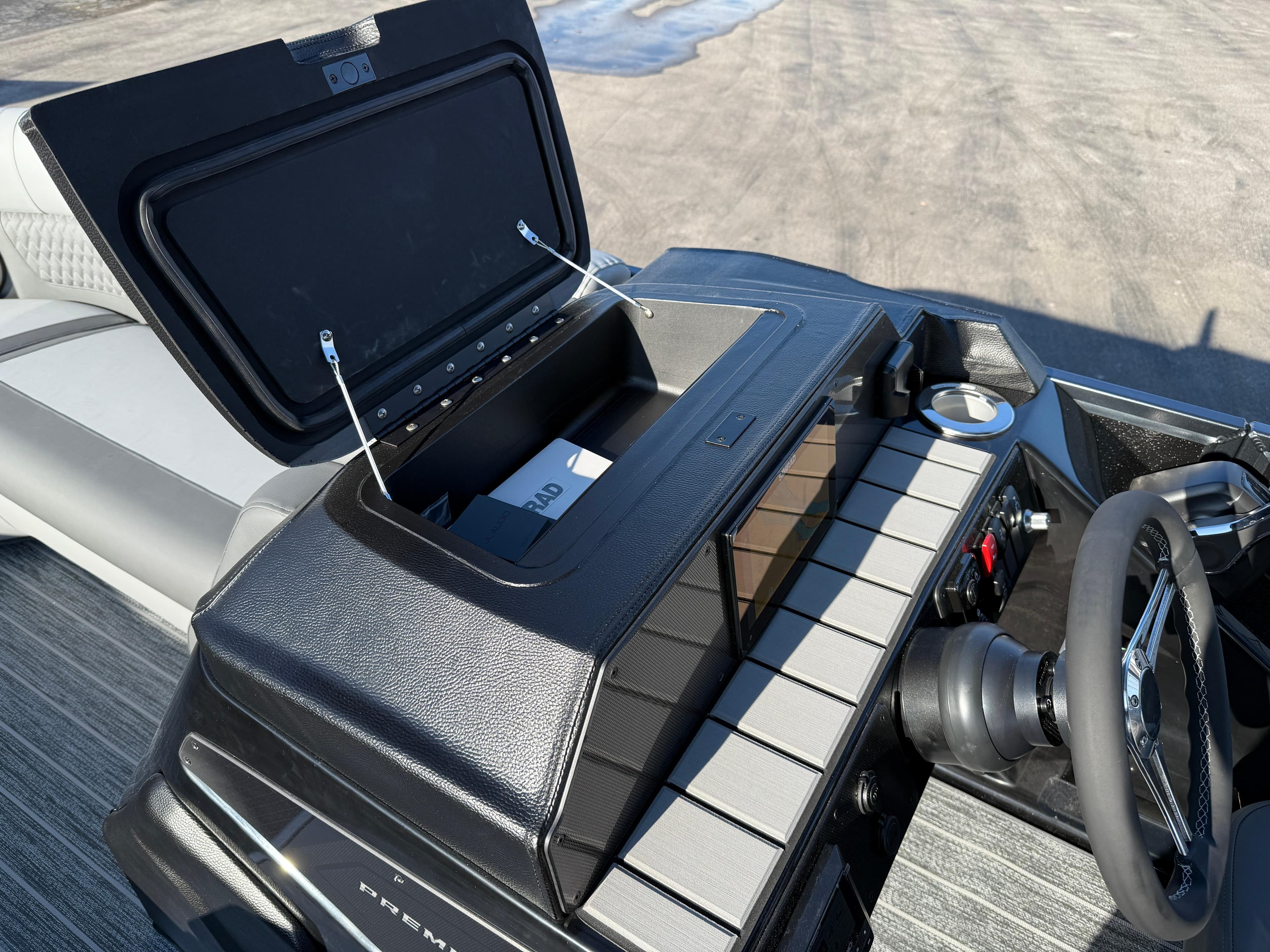 2025 Premier 230 Solaris RL dashboard with open storage compartment and steering wheel.