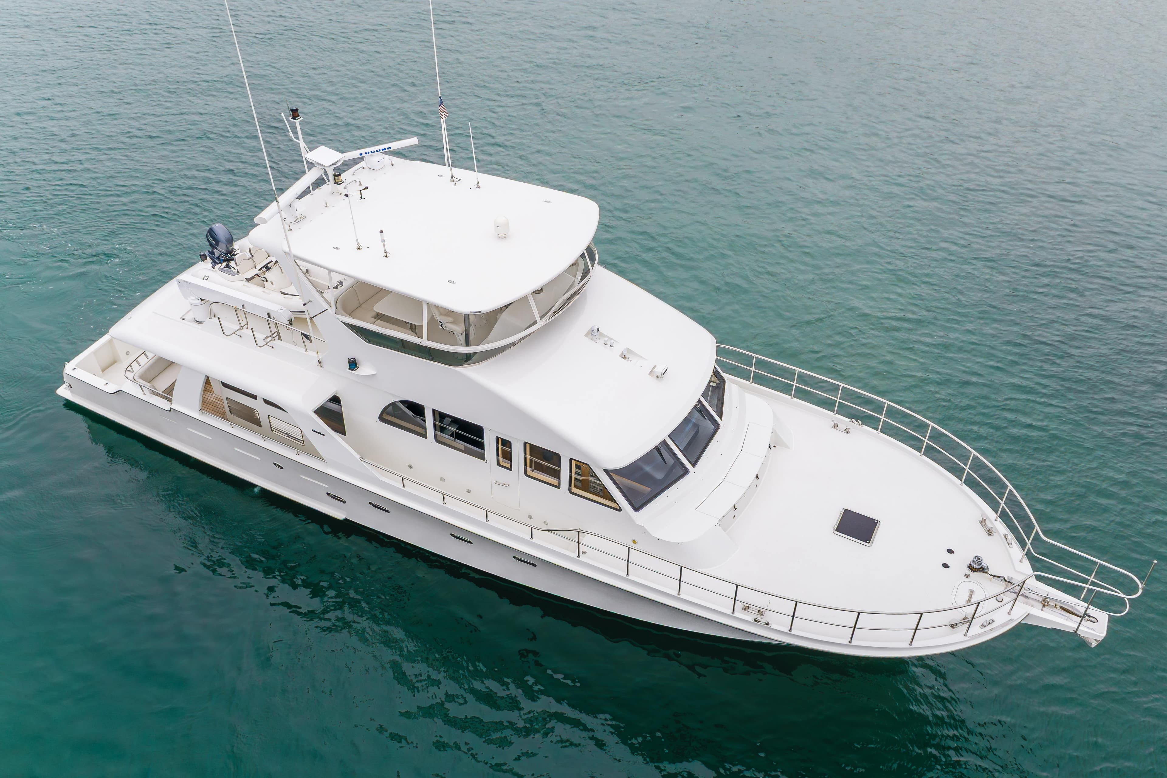 2006 Cheoy Lee 72' Raised Pilot House yacht on calm water.