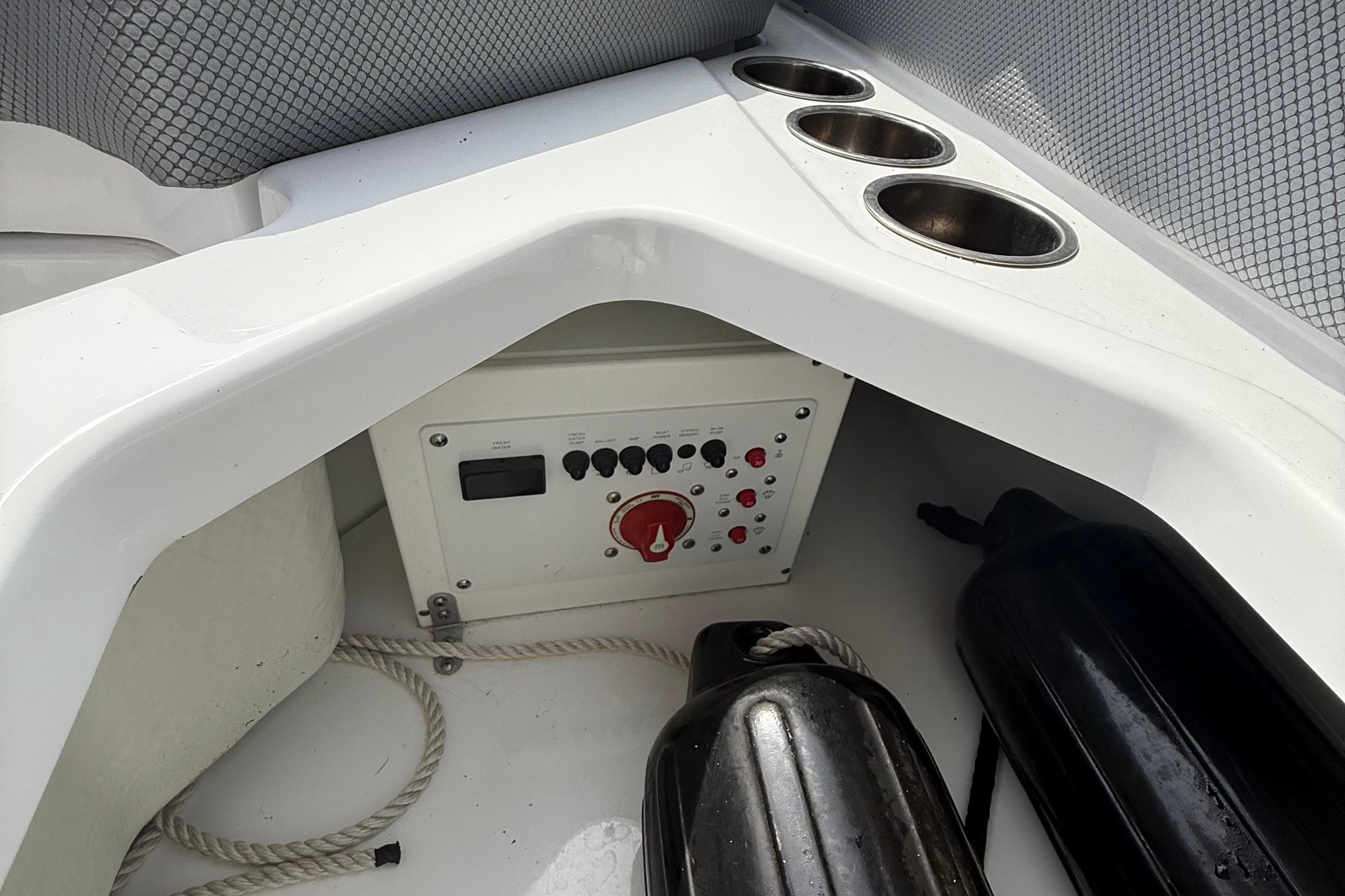 Interior of 2025 Scarab 235SE boat with control panel and cup holders.