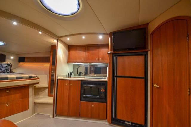 Interior of 2002 Cruisers Yachts 3870 Express with kitchen and sleeping area.