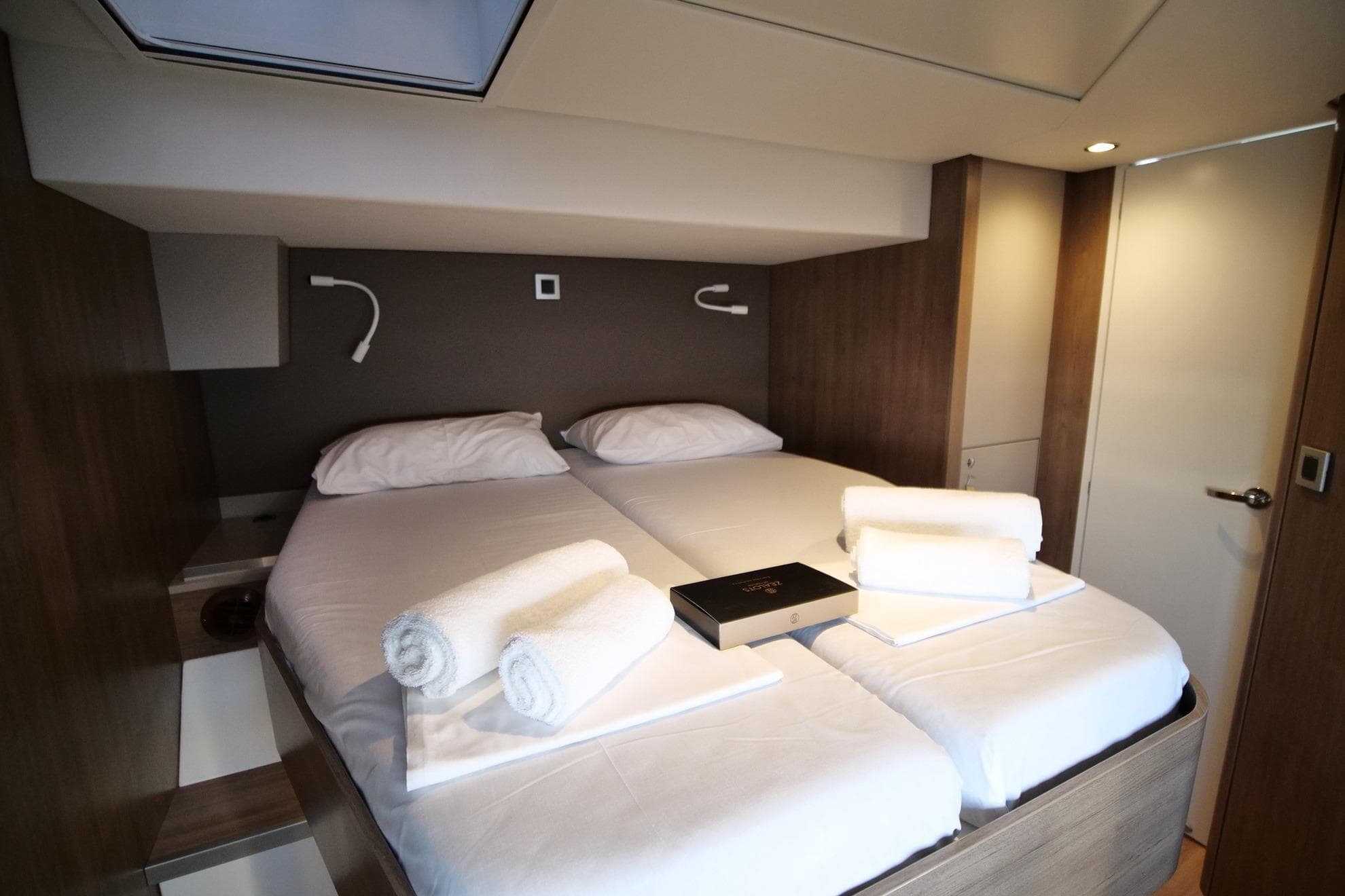 Luxurious cabin interior of 2022 Bali 4.8 yacht with twin beds and modern decor.