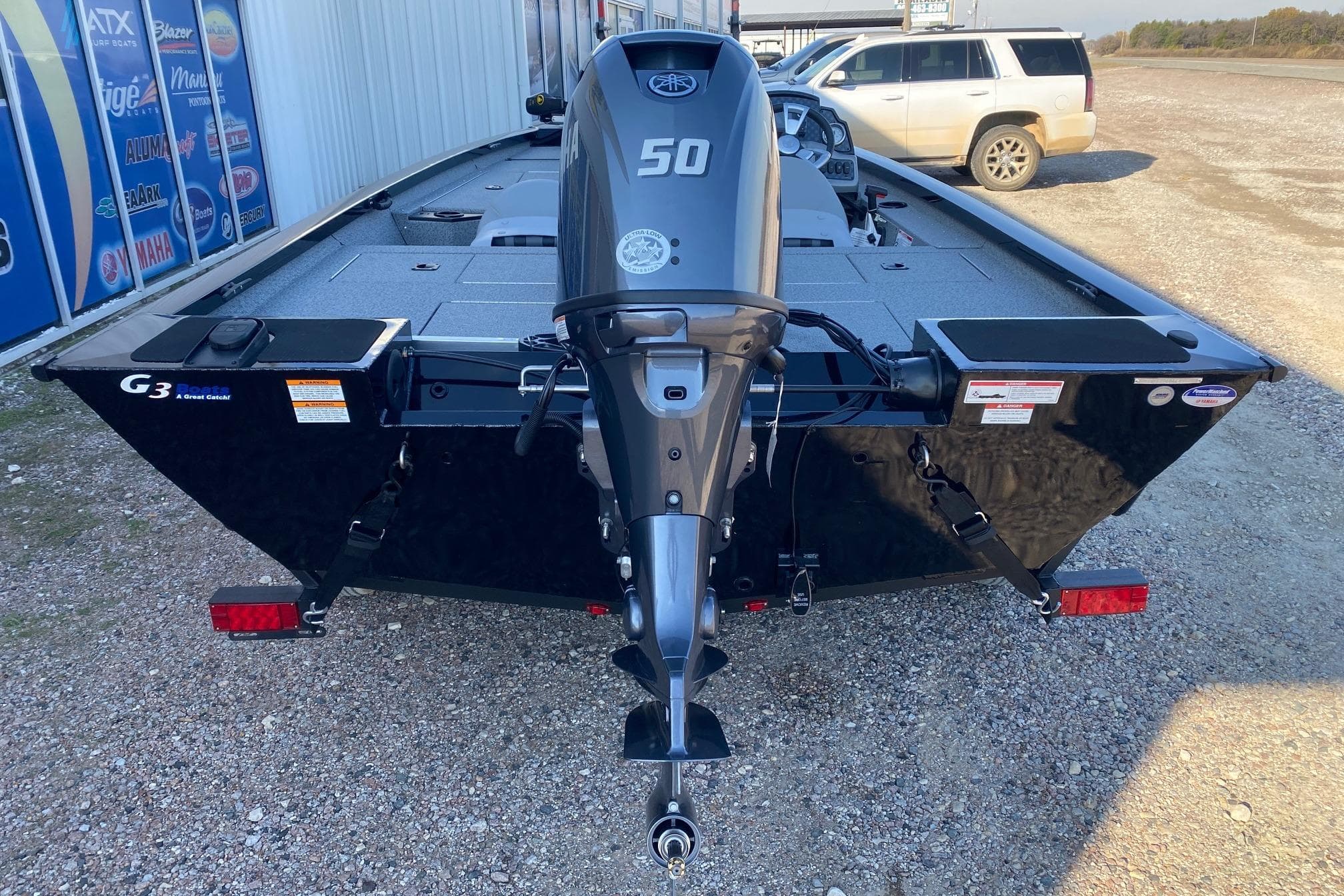 2026 G3 Sportsman 1610 boat with 50 HP motor, parked outdoors.