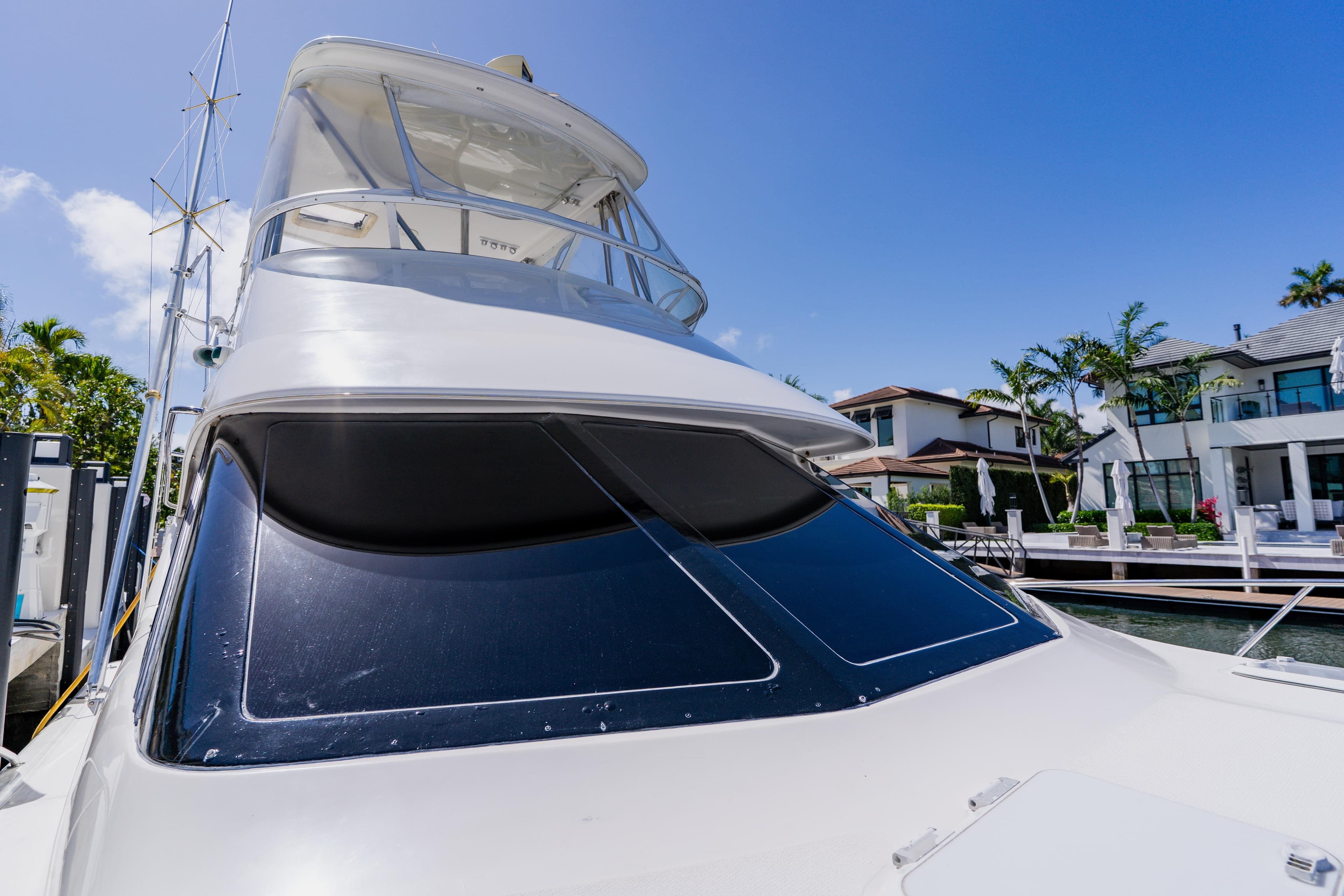 2003 Wellcraft 400 Coastal yacht docked near luxury waterfront homes.