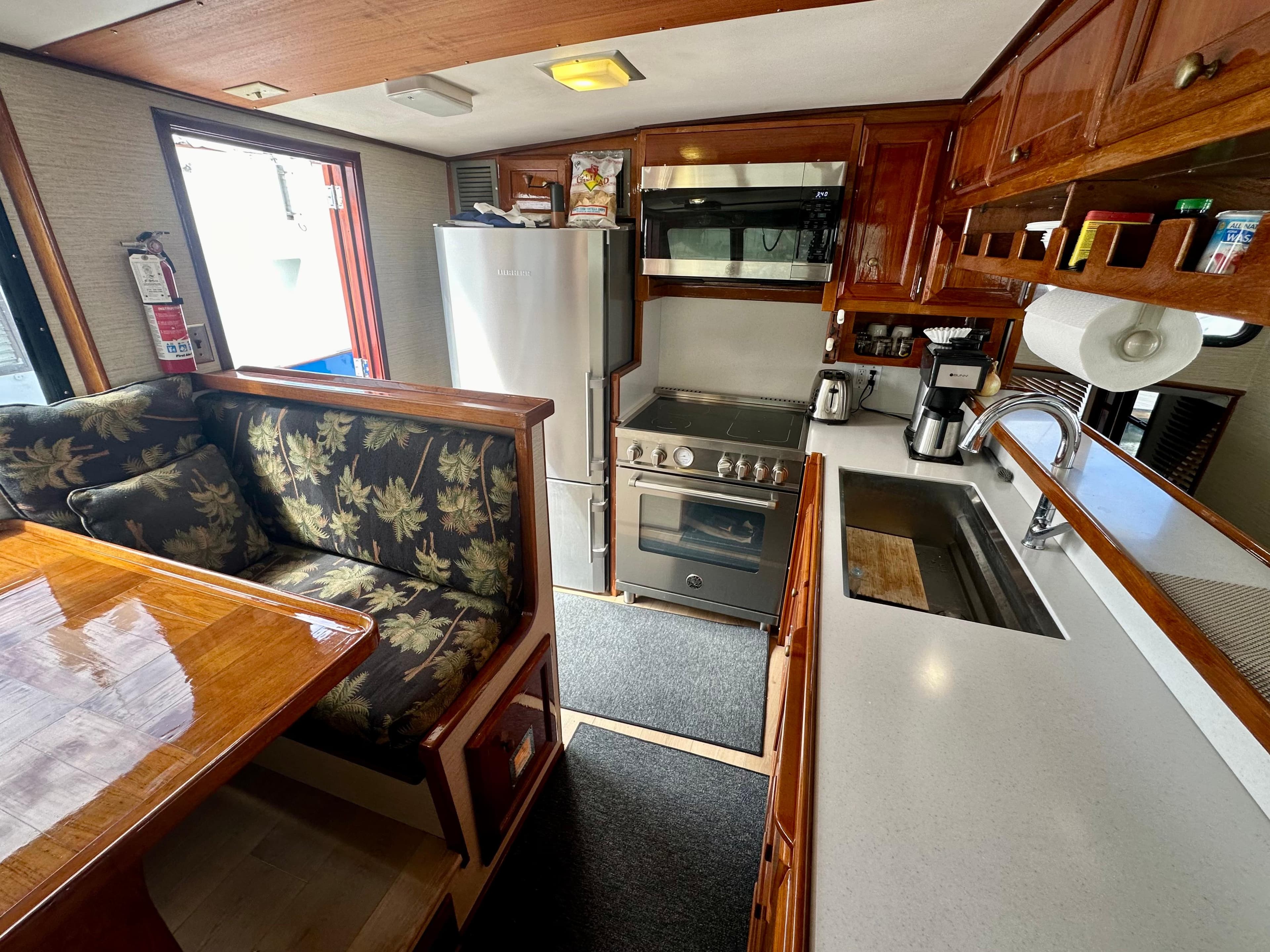 Interior of 1976 Ditmar & Donaldson Custom Yachtfisher with kitchen and dining area.