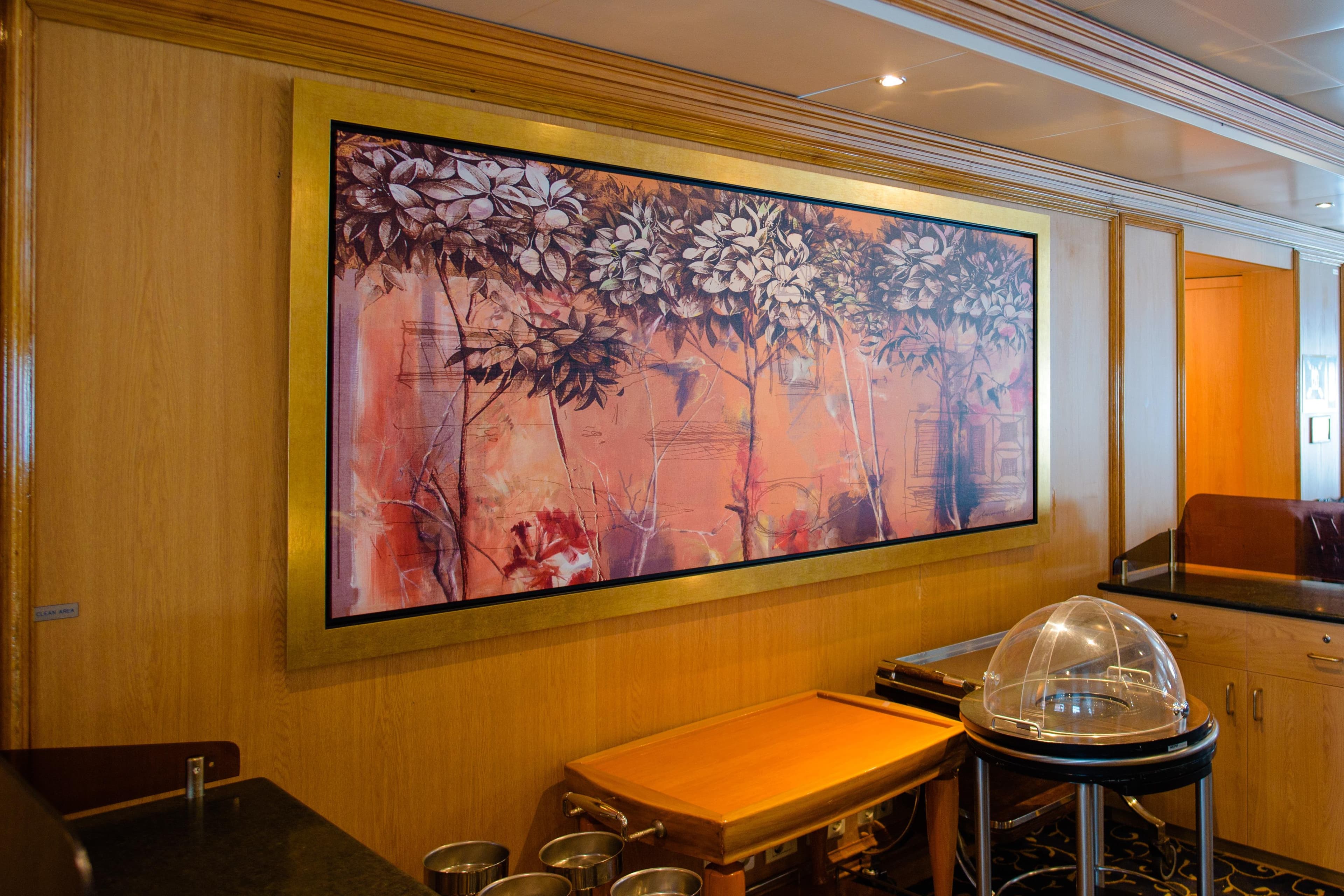Interior of 1996 MINERVA cruise ship featuring framed floral artwork on wooden wall.