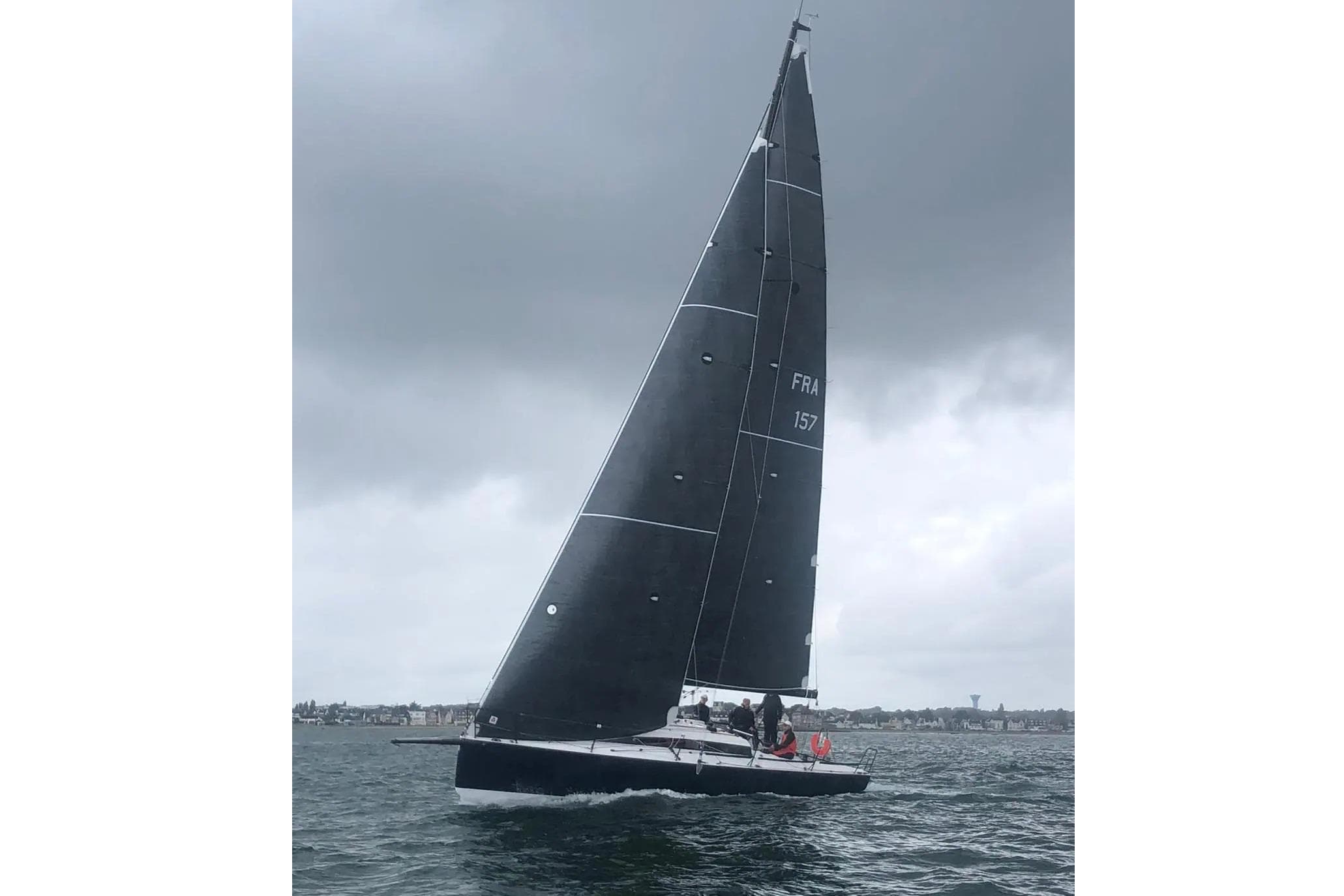 Sailing yacht JPK 11.80, 2020 model, navigating under cloudy skies.