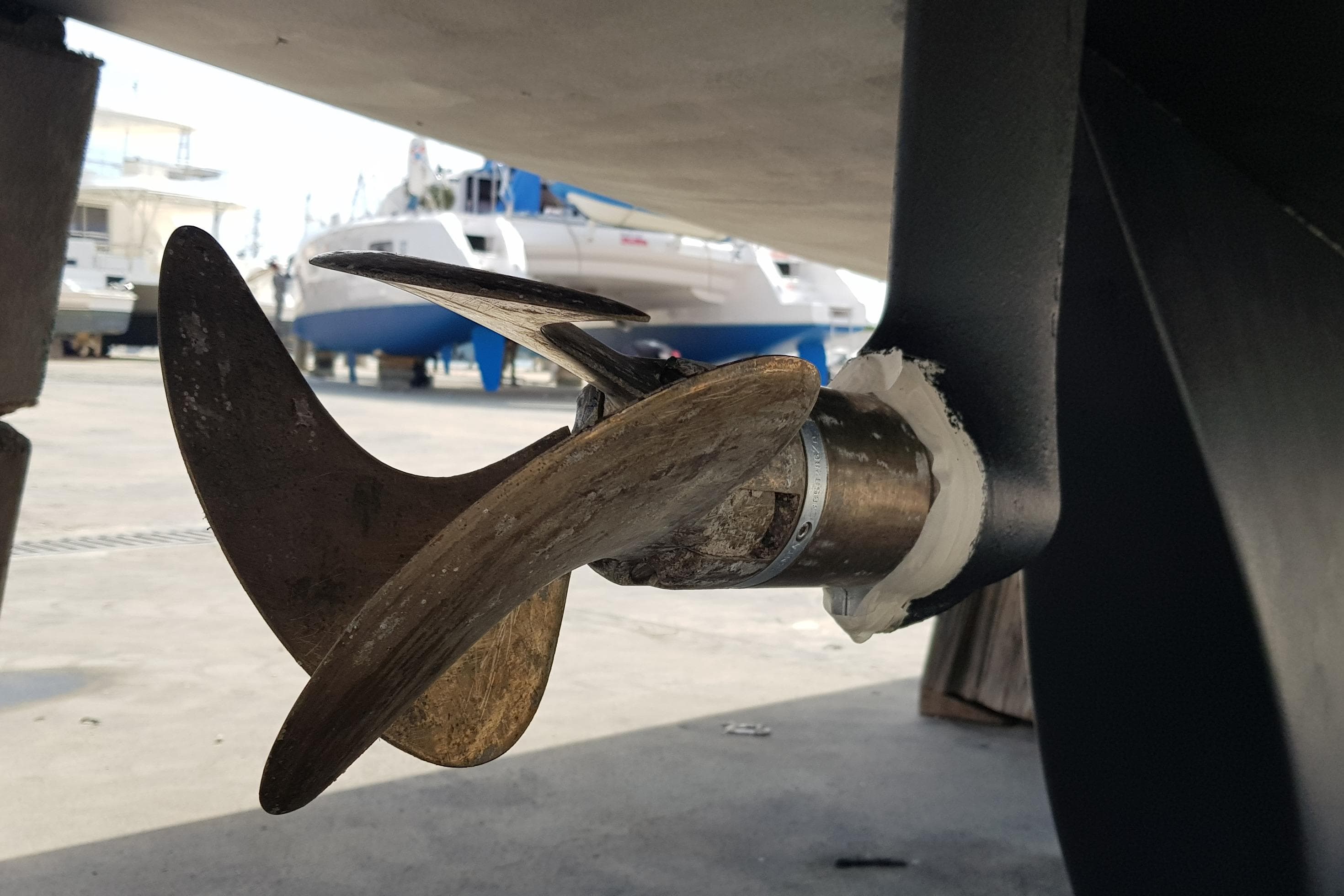 Close-up of a 2017 Pogo 12.50 sailboat propeller in a boatyard setting.