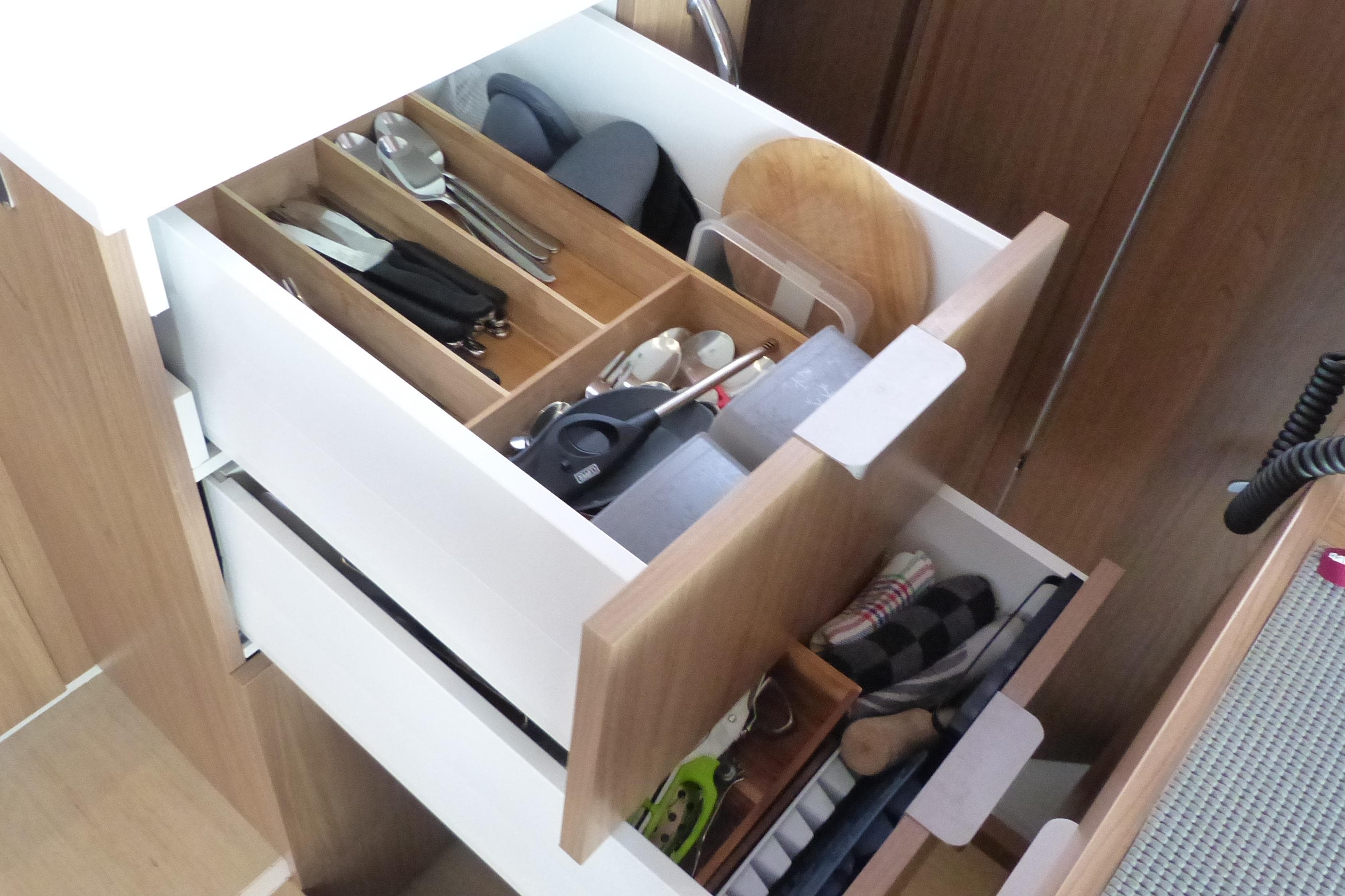 Open kitchen drawers with organized utensils in a Bali CATSMART 2024 model.