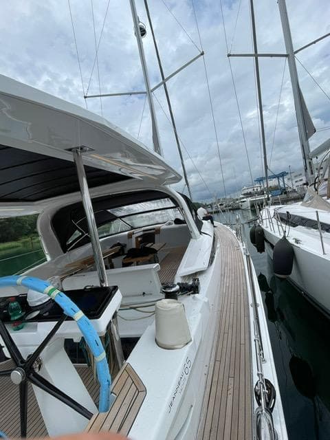 2023 Jeanneau 65 yacht docked, showcasing sleek design and spacious deck.
