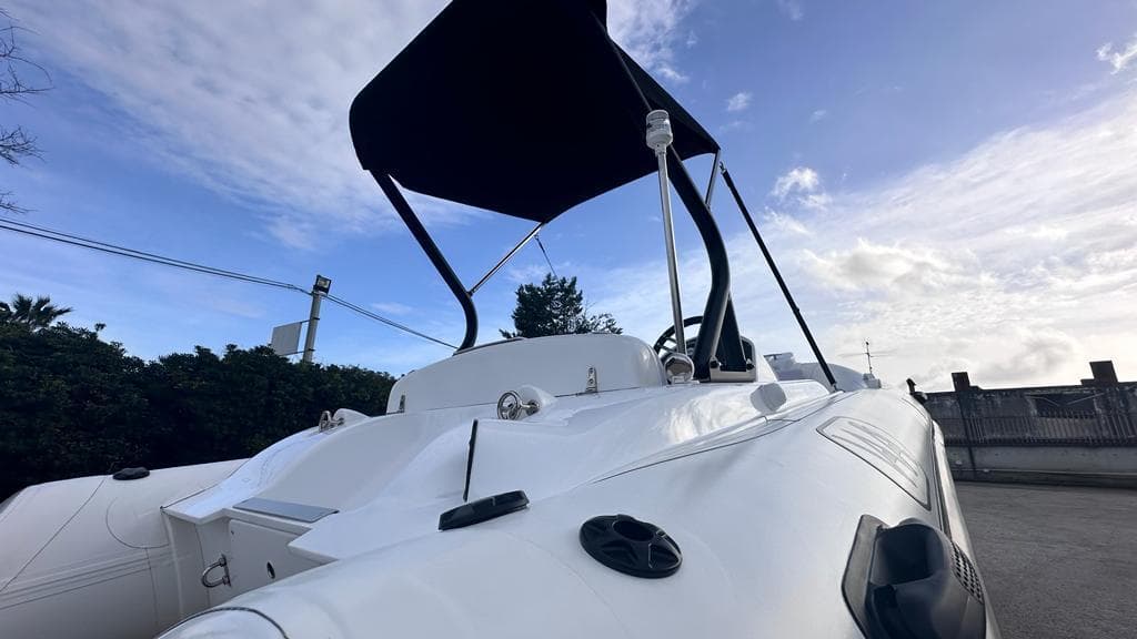 2024 Aqvaboats LUXRIB 14 with canopy, sleek white design, and modern features.