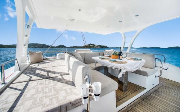 Luxurious Sunreef 60 LOFT yacht deck with elegant dining area, 2016 model, scenic ocean view.
