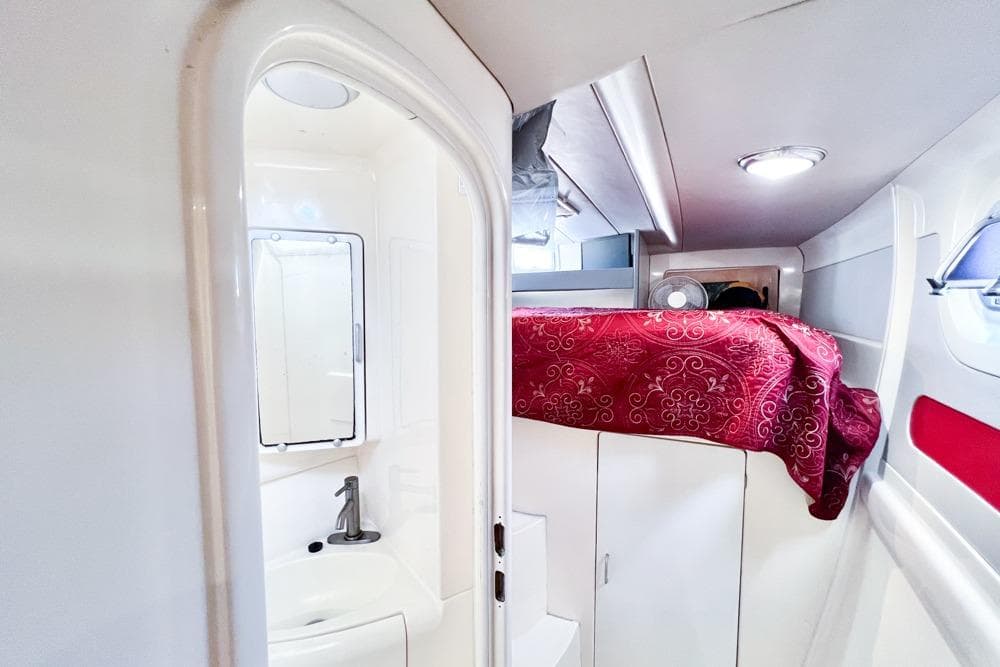 Interior of 2000 Leopard 38 yacht with compact bathroom and cozy cabin.