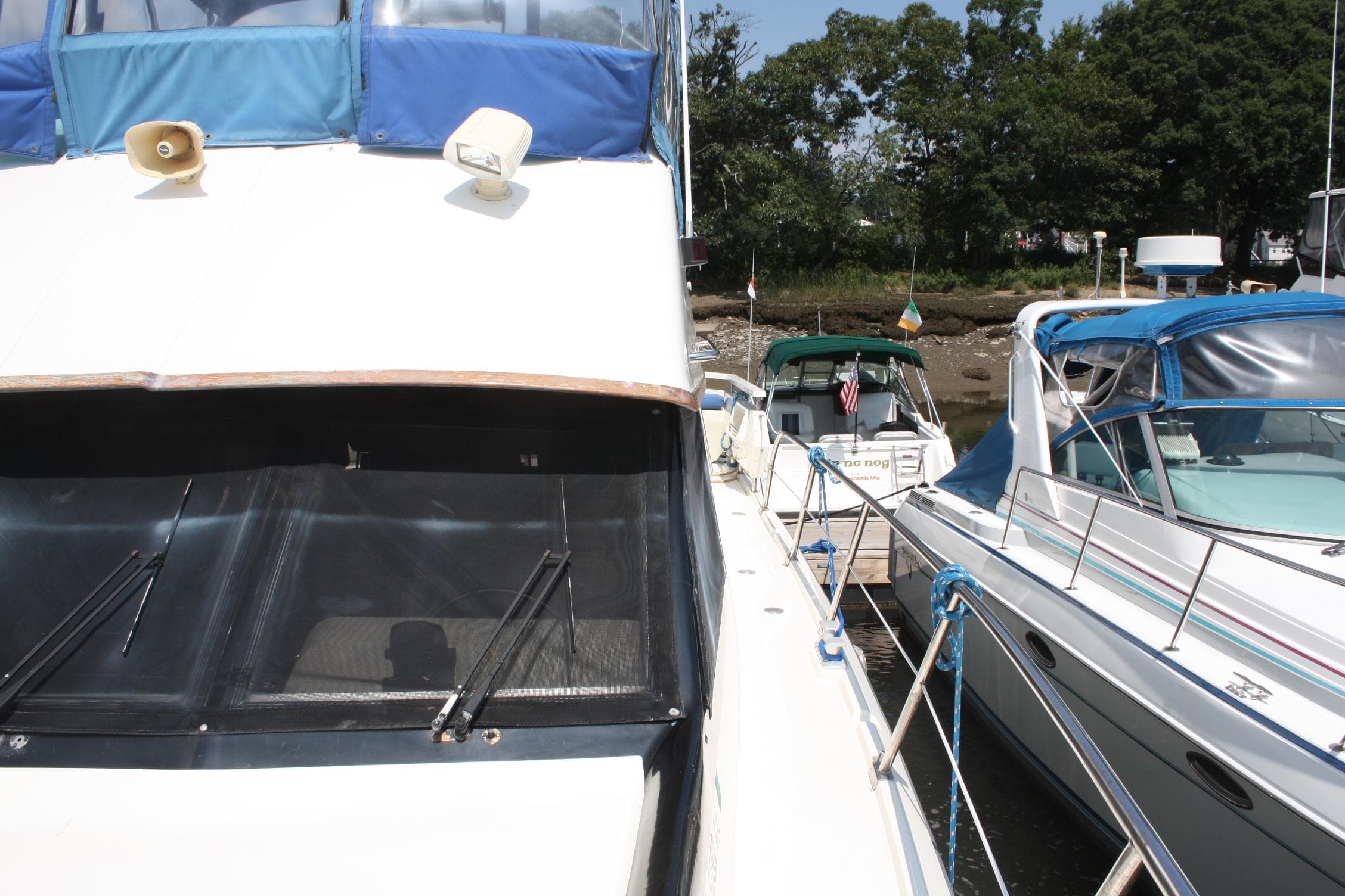 1986 Birchwood 42 Empress yacht docked alongside other boats in a marina.