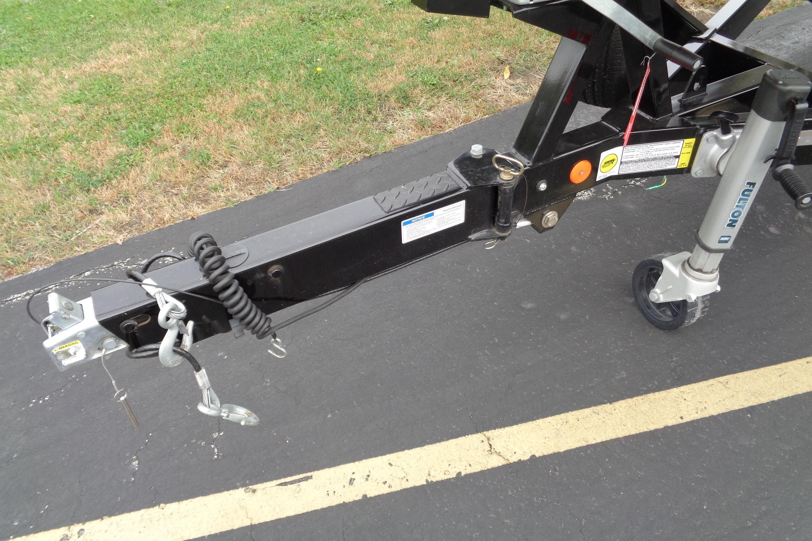 Trailer hitch of 2020 MasterCraft XT23 boat on pavement.