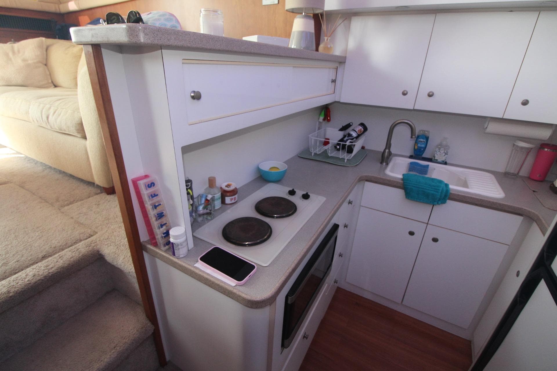 Compact kitchen in a 1996 Silverton 41 Convertible yacht with modern amenities.