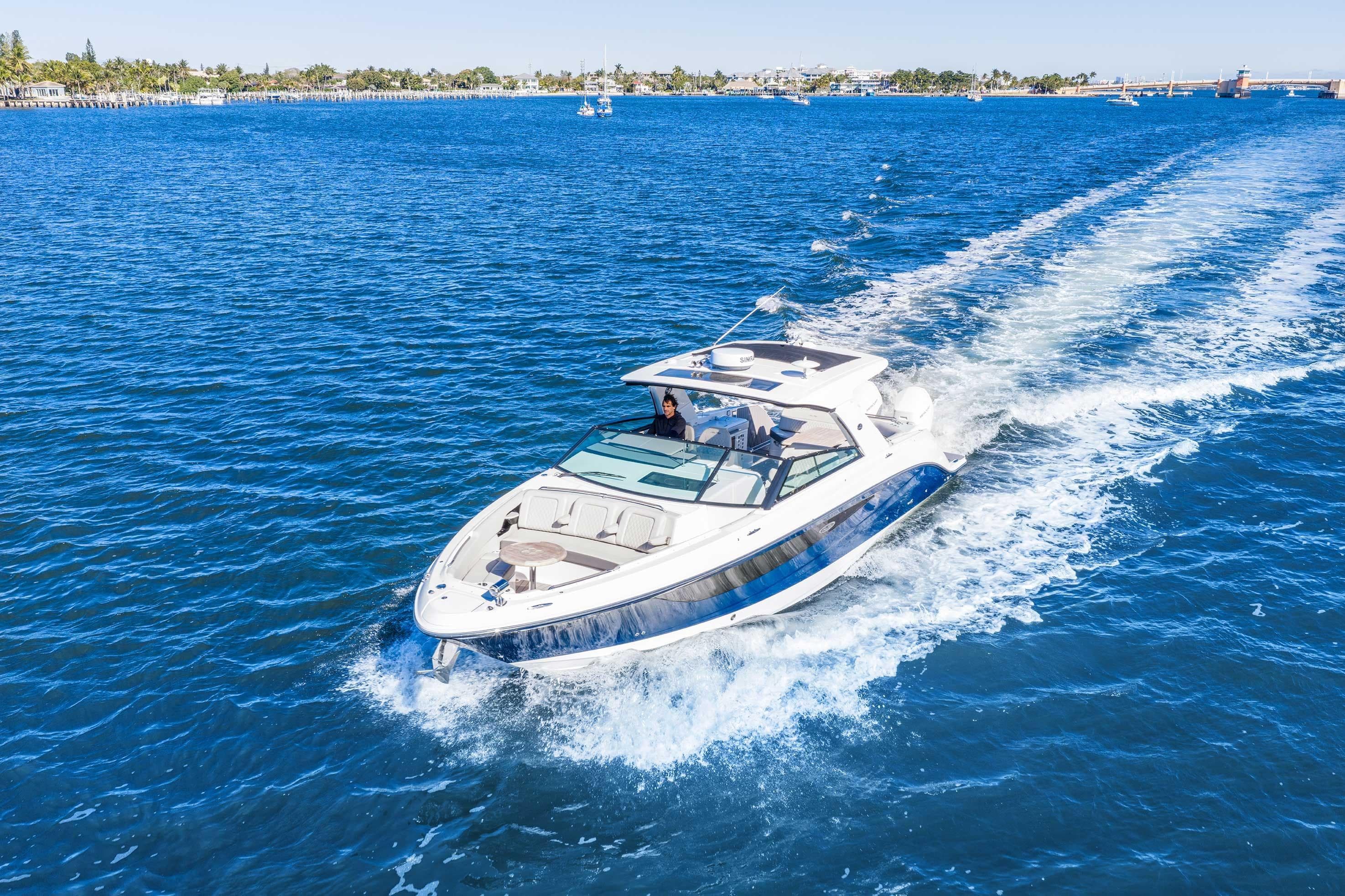 2023 Sea Ray SLX 400 Outboard cruising on clear blue water.
