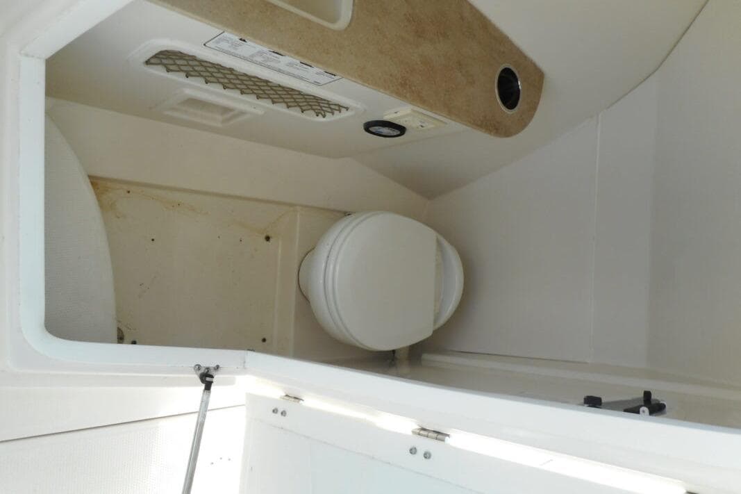 Interior view of a 2020 Sailfish 275 DC boat's compact bathroom area.