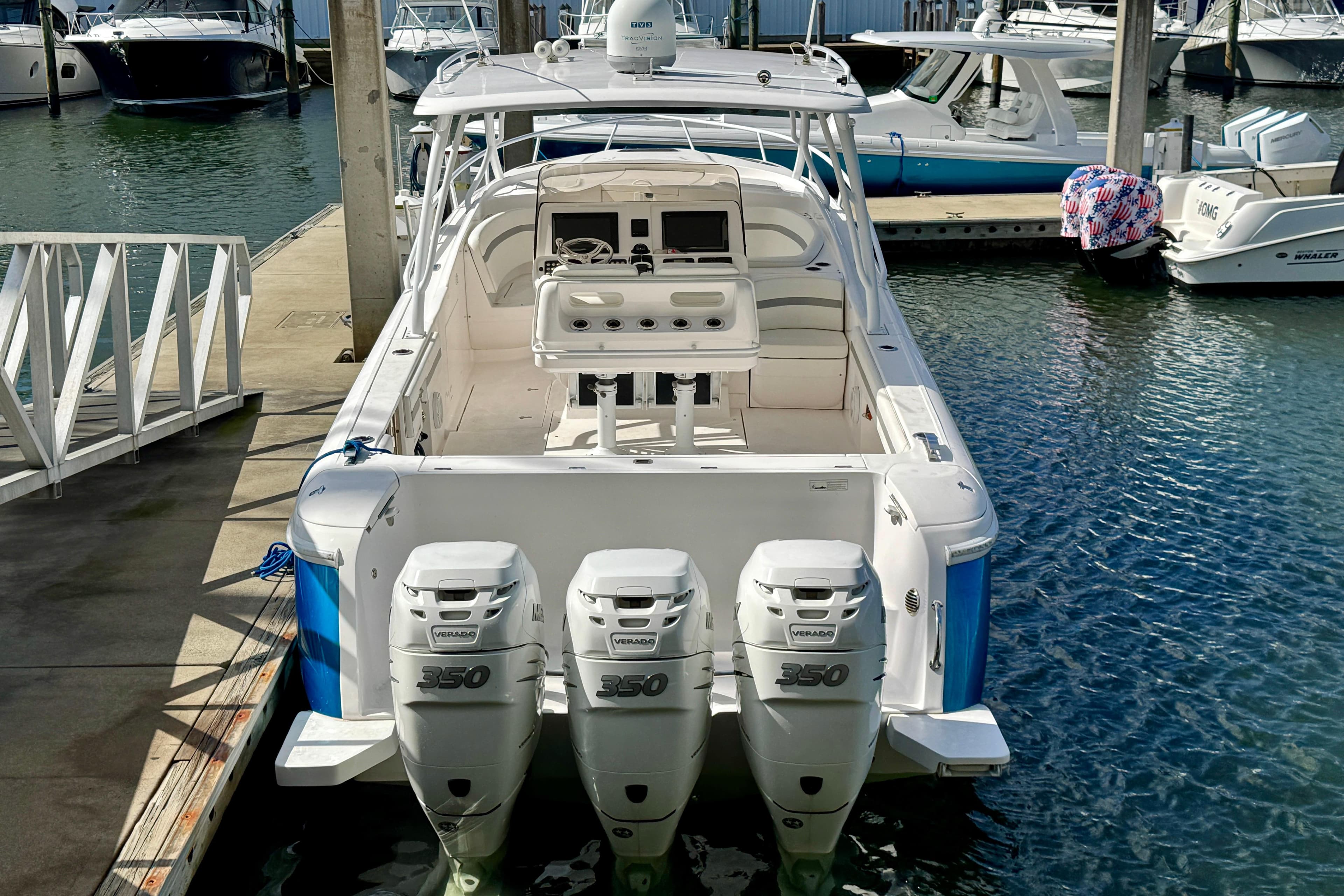 2019 Intrepid 407 Cuddy boat docked, featuring triple 350 horsepower engines.