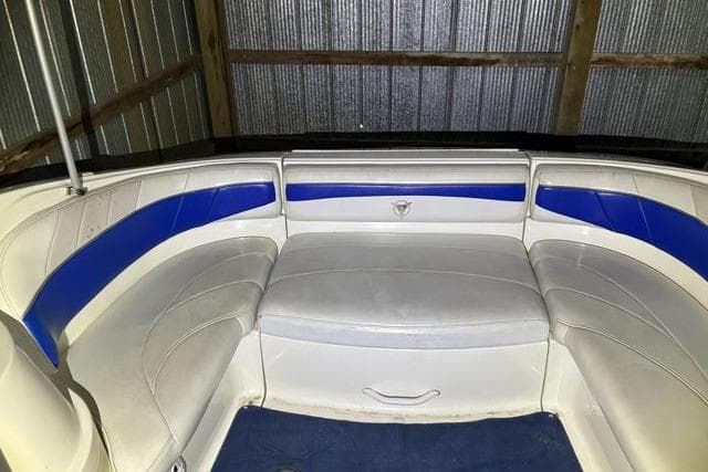 Interior seating of 2001 Campion Allante 705 boat with blue and white upholstery.