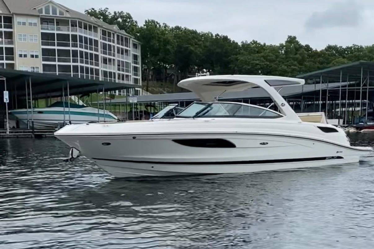 2015 Sea Ray SLX 350 boat docked near waterfront buildings.