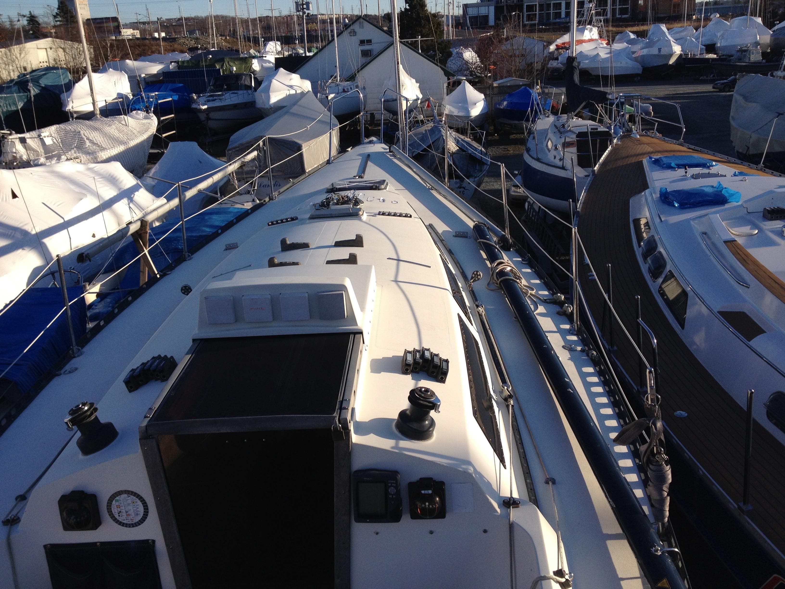 1987 Abbott 36 DK sailboat in harbor, surrounded by other boats.