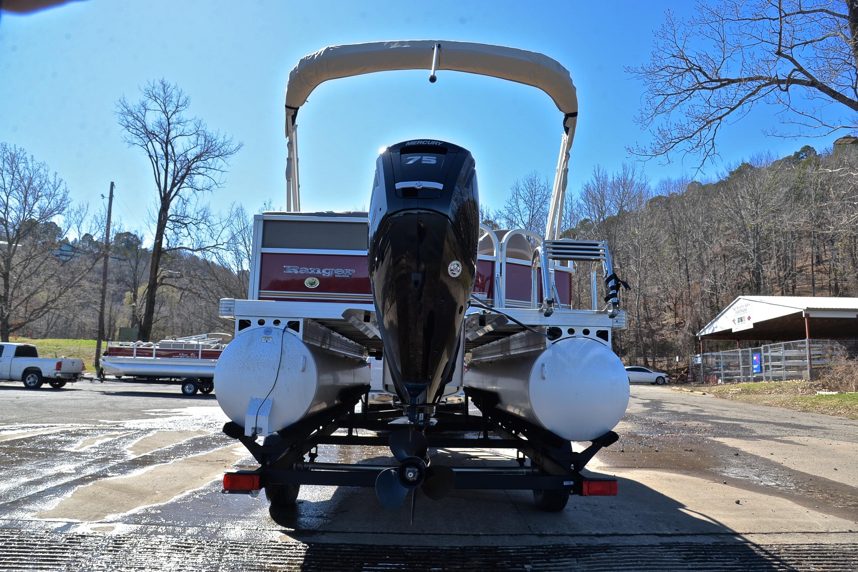 2021 Ranger 180 Reata boat on trailer, rear view, outdoors in a parking area.