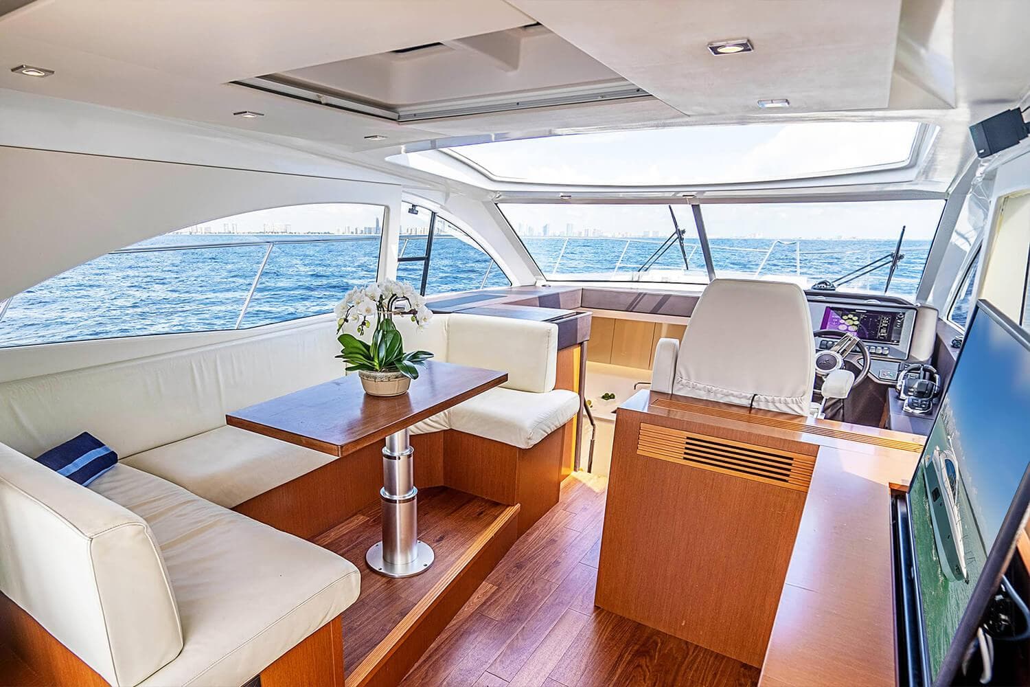 Luxurious interior of 2017 Beneteau Gran Turismo yacht with ocean view and elegant seating.