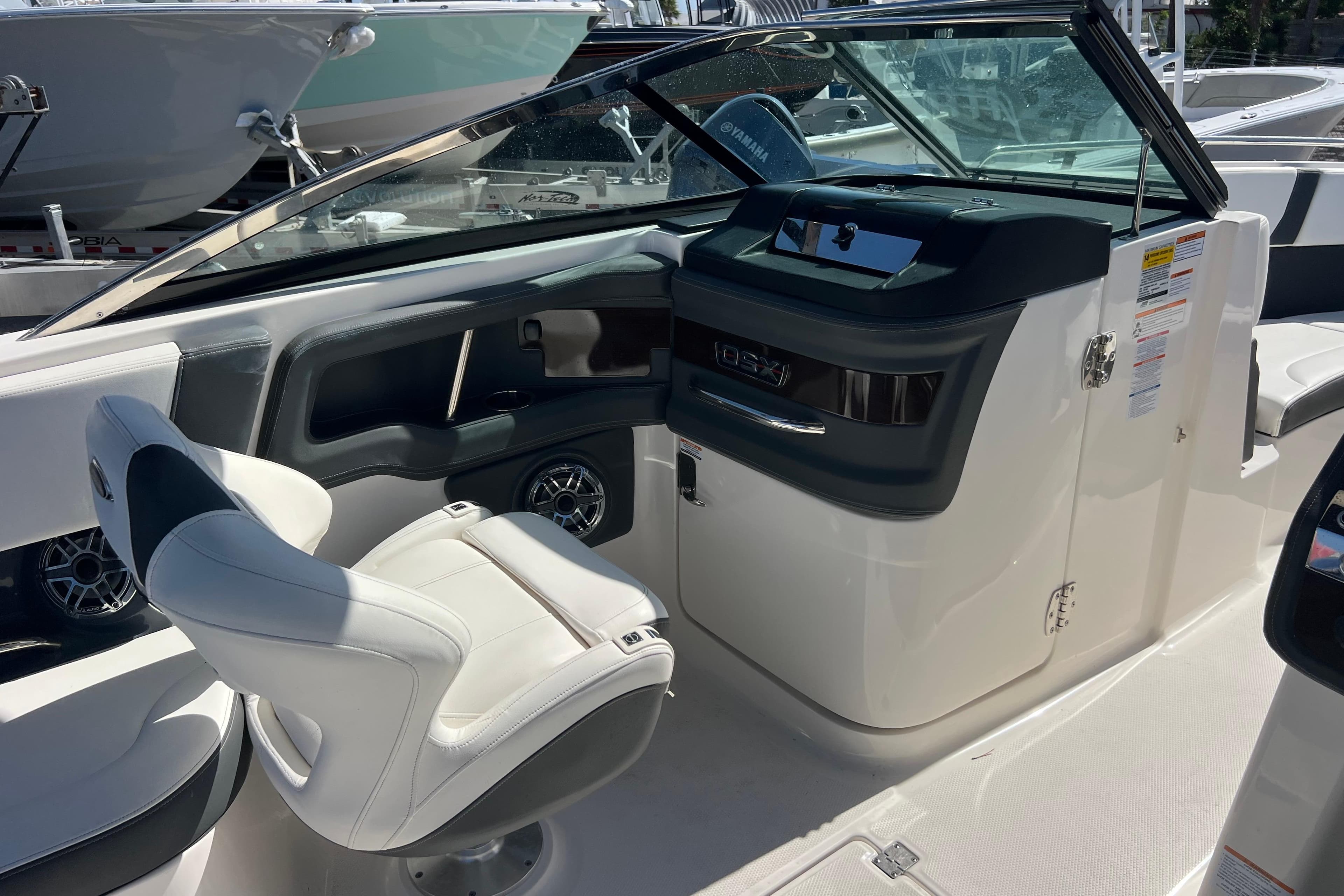 2023 Chaparral 270 OSX boat interior with helm and seating area.