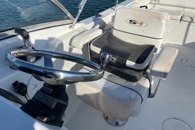 2014 Sea Hunt Escape 235 SE boat cockpit with steering wheel and seating.