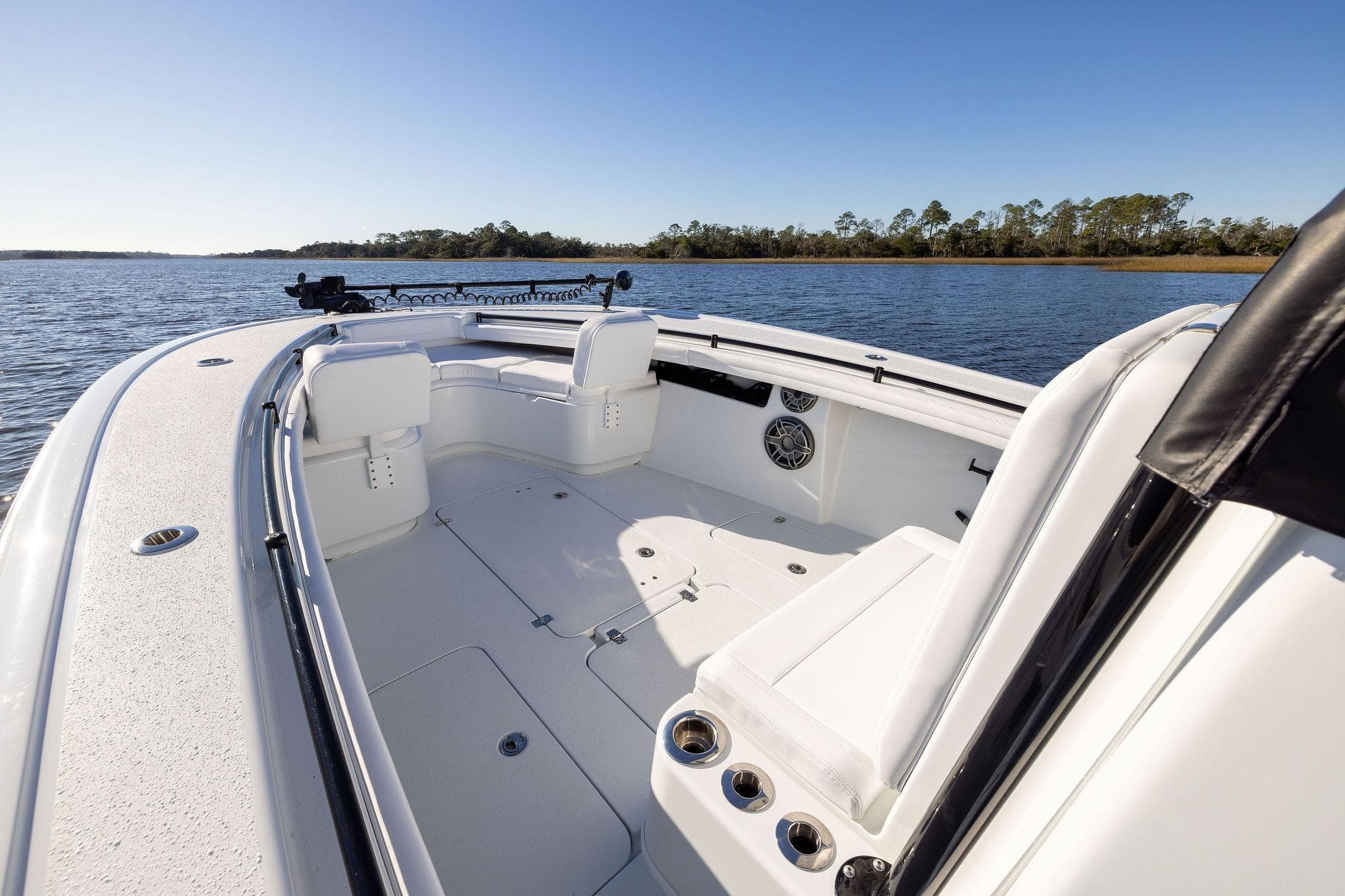 2023 Yellowfin 32 Offshore boat interior with seating, on a calm lake.