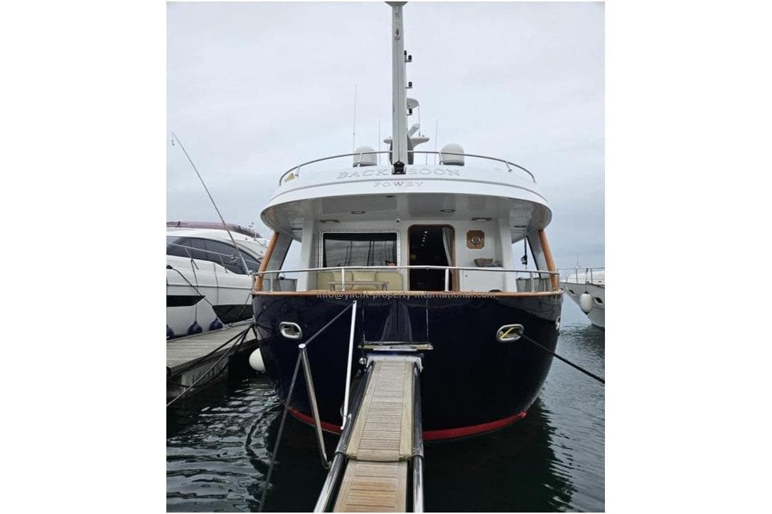 2015 Benetti 79 yacht docked, rear view, showcasing elegant design and spacious deck.
