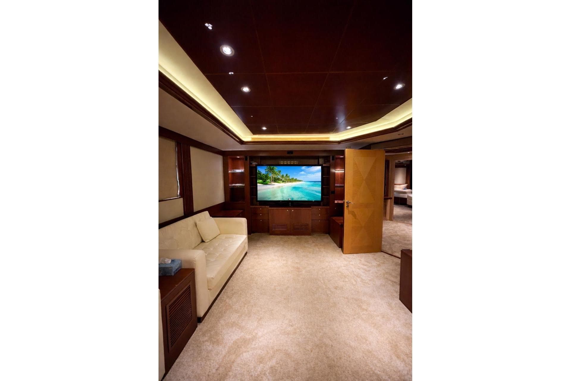 Luxurious yacht interior with plush seating, large TV, and elegant wood finishes, Riviera 2010.