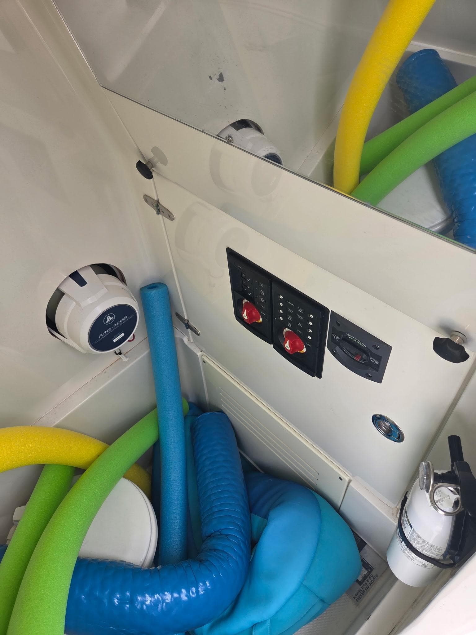 Interior of 2015 Jupiter 26 FS boat with pool noodles and control panel.