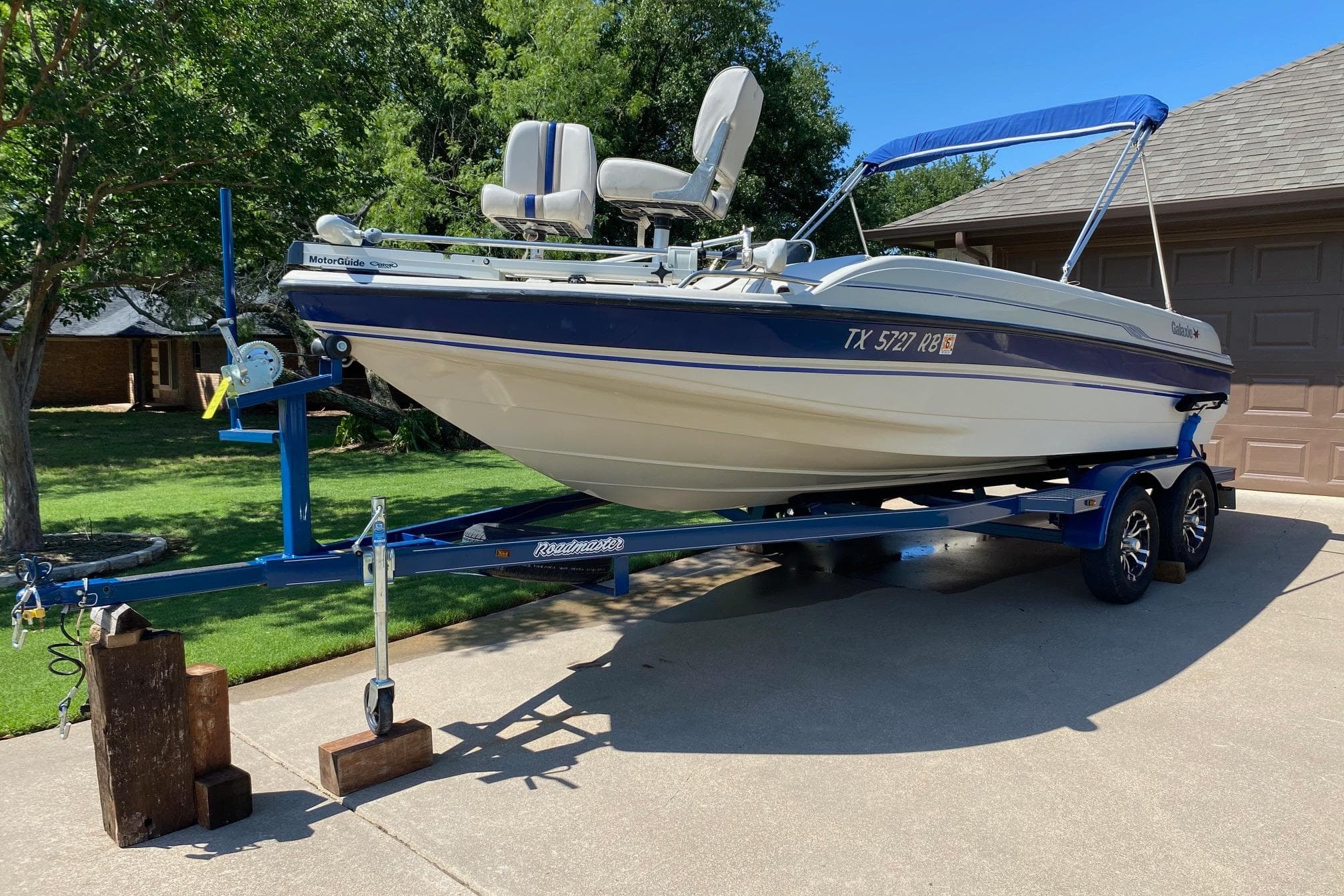 2003 Galaxie 2100 Ultra F & S boat on trailer, parked in driveway.