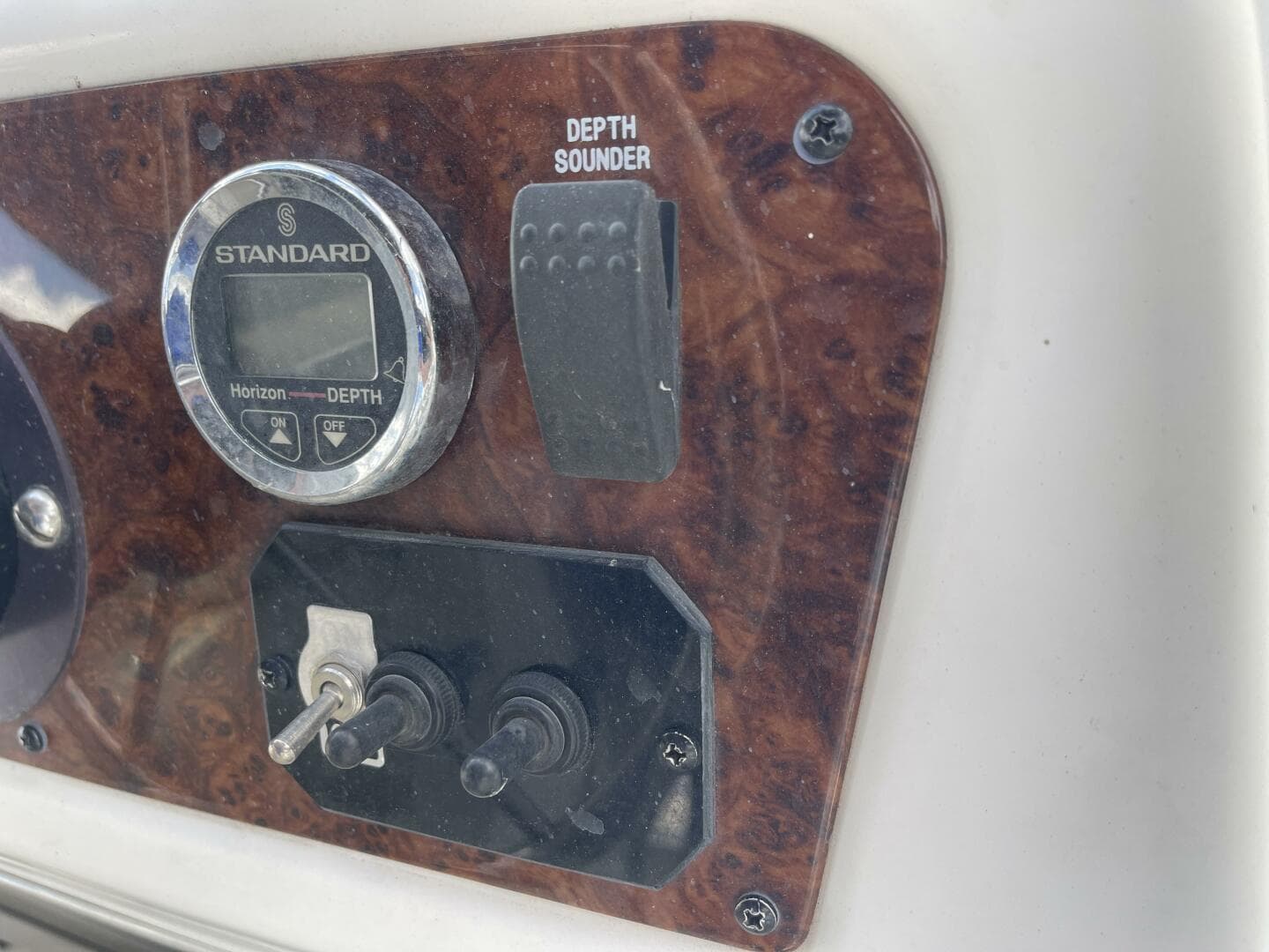 Control panel of a 2001 Bayliner 3258 Ciera Command Bridge with depth sounder.