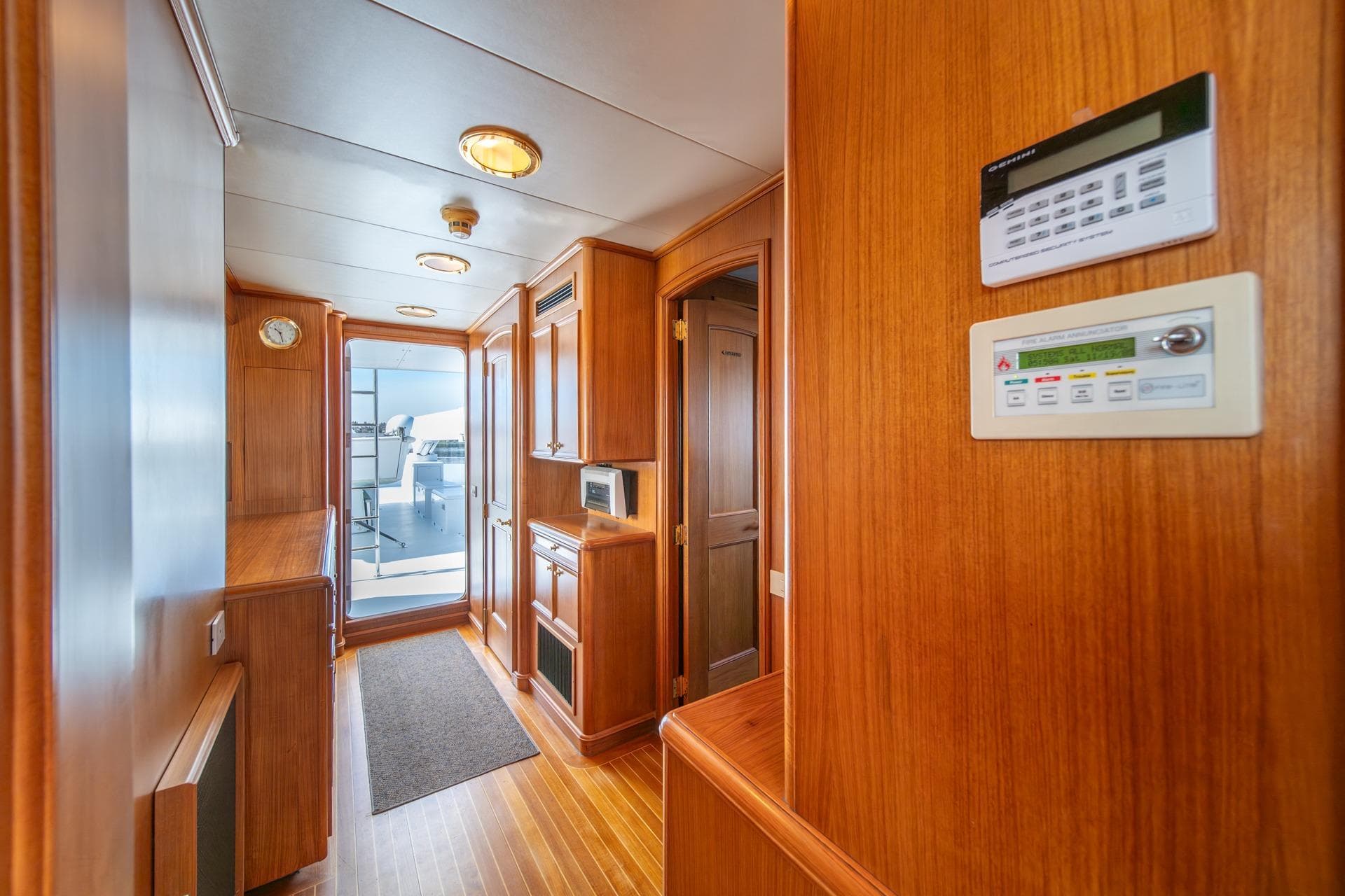 Luxurious wooden interior of 1997 Trident Tri-Deck Exploration Cockpit Motor Yacht hallway.