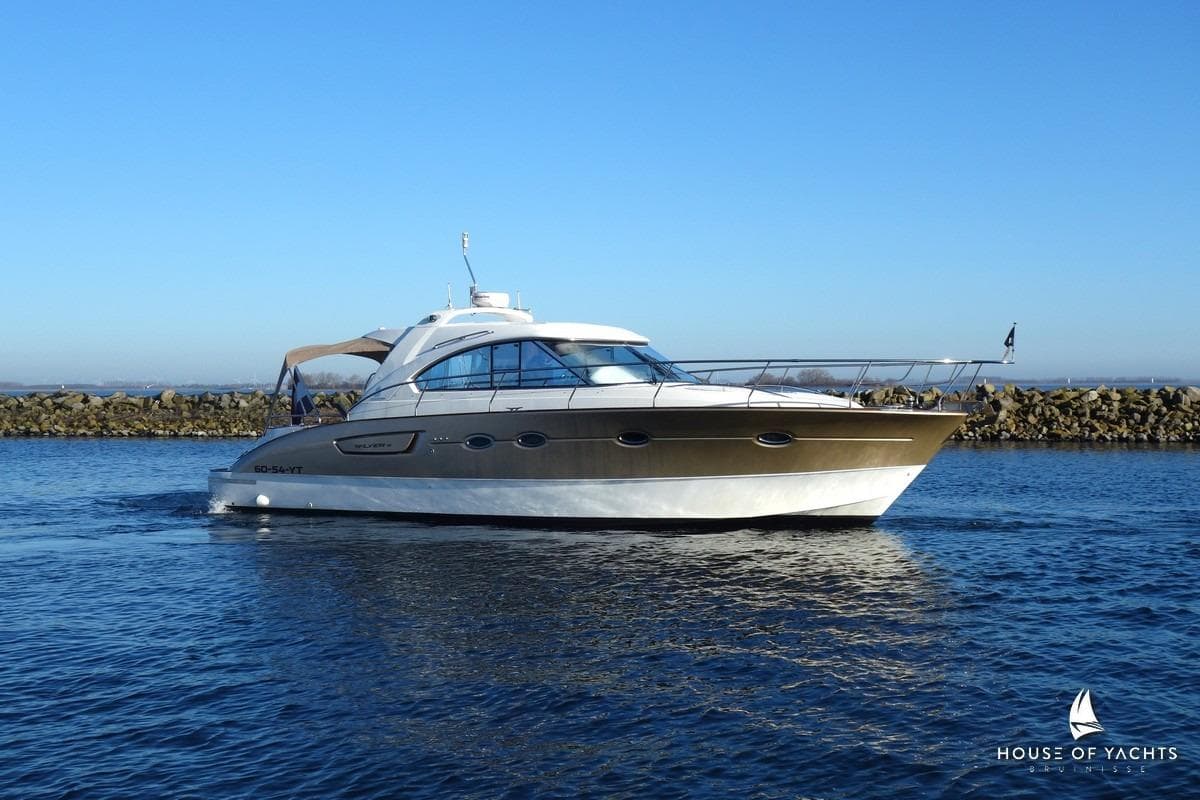 2005 Beneteau Flyer 12 yacht cruising on calm waters under clear blue sky.