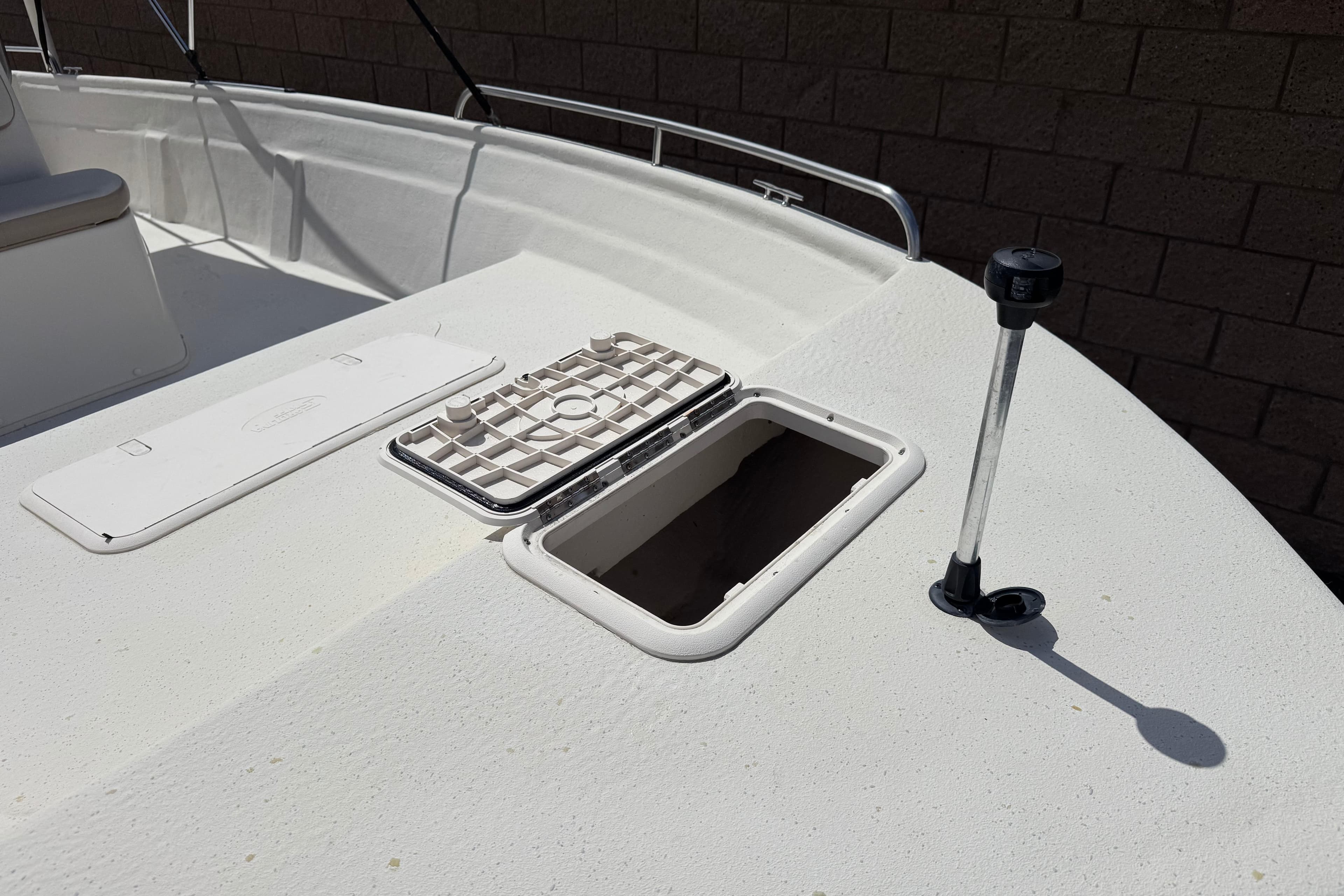 2013 Carolina Skiff Sea Chaser 1950 RG deck with open hatch and railing.