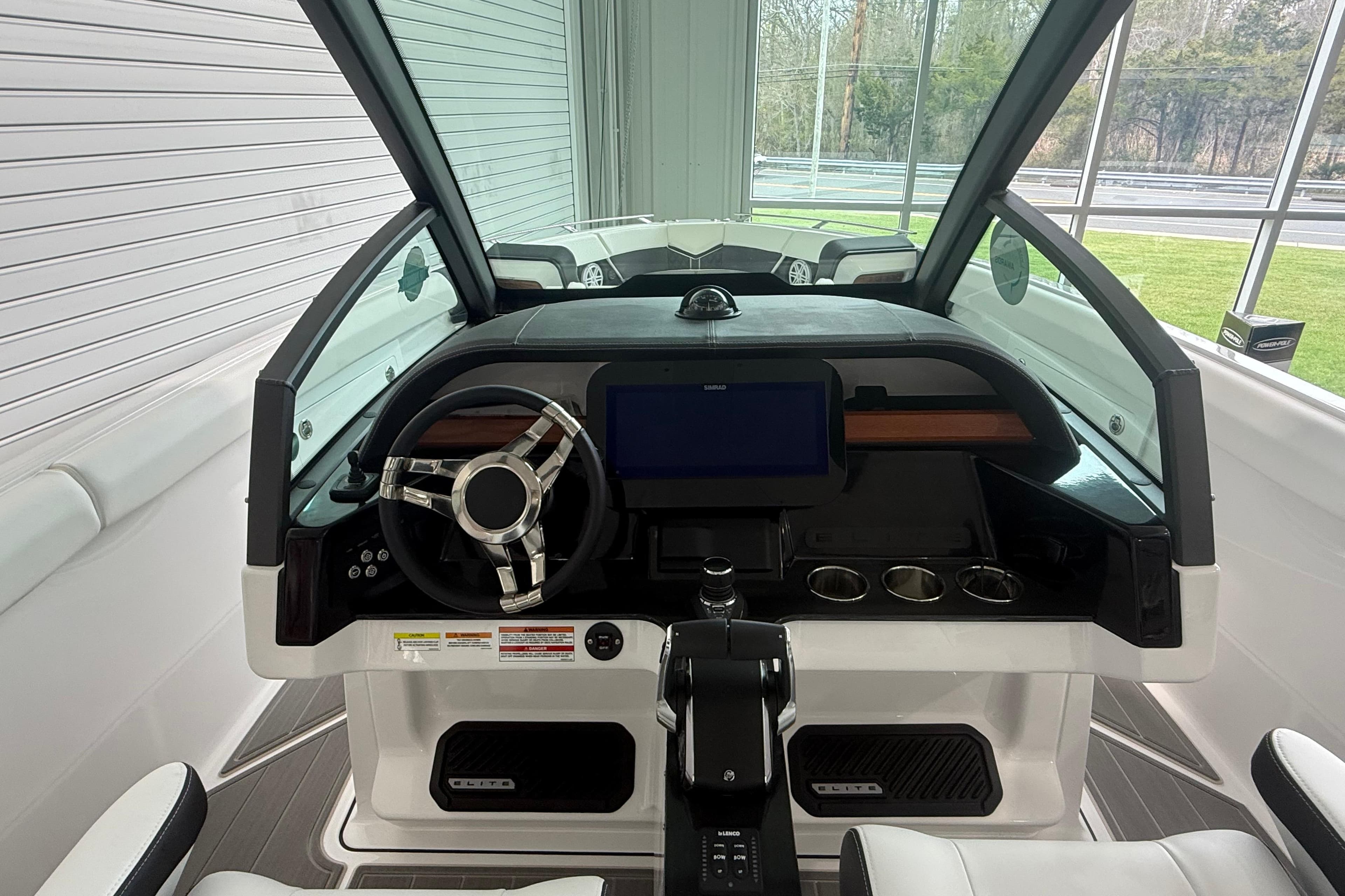 2026 Monterey Elite 30 OB boat cockpit with modern steering and dashboard controls.