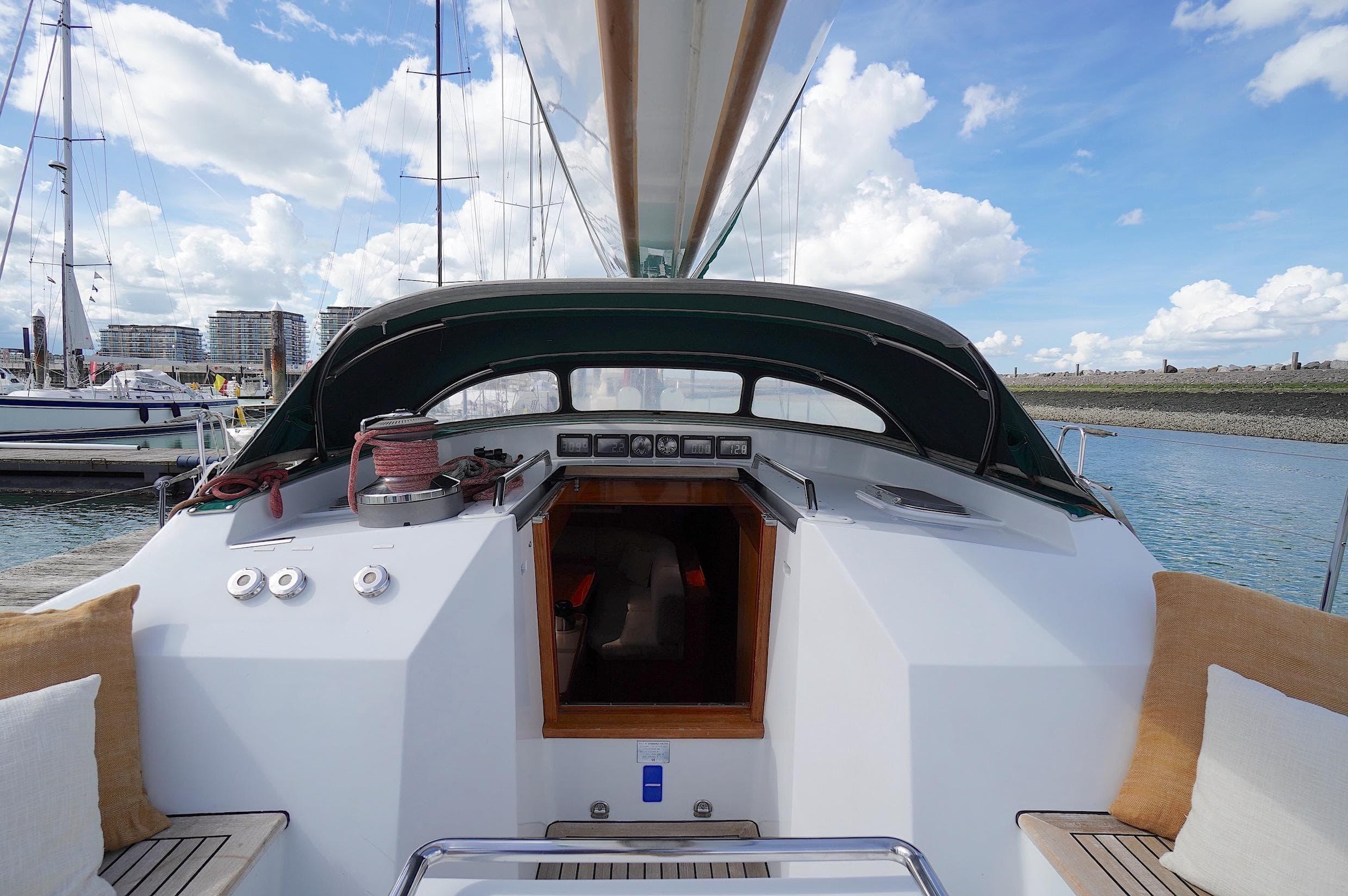Standfast 64 sailboat cockpit view, 2002 model, docked in a marina under a blue sky.