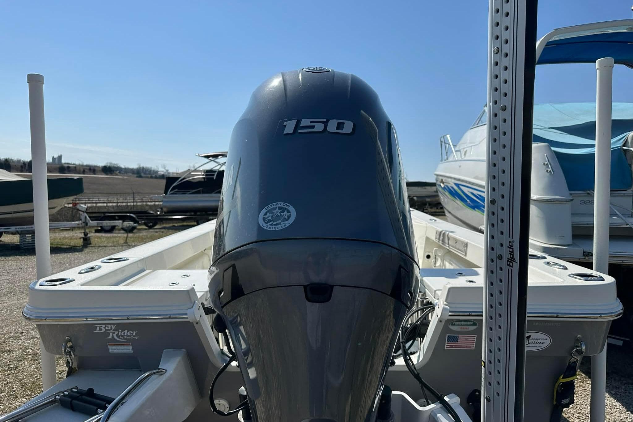 2022 BayRider Kencraft 219 Bay boat with 150 horsepower engine, docked outdoors.