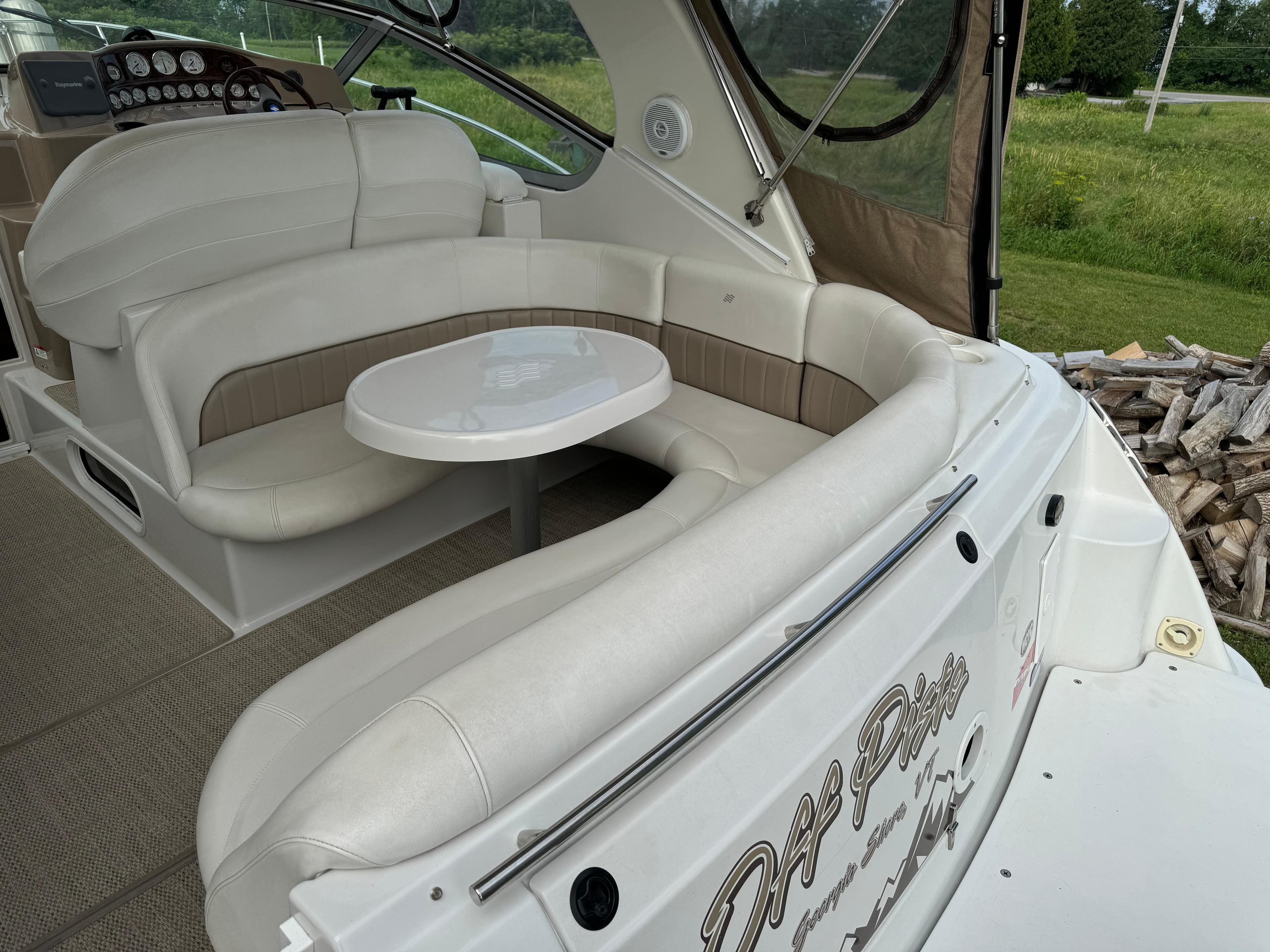 2005 Four Winns 328 Vista boat interior with white seating and table.