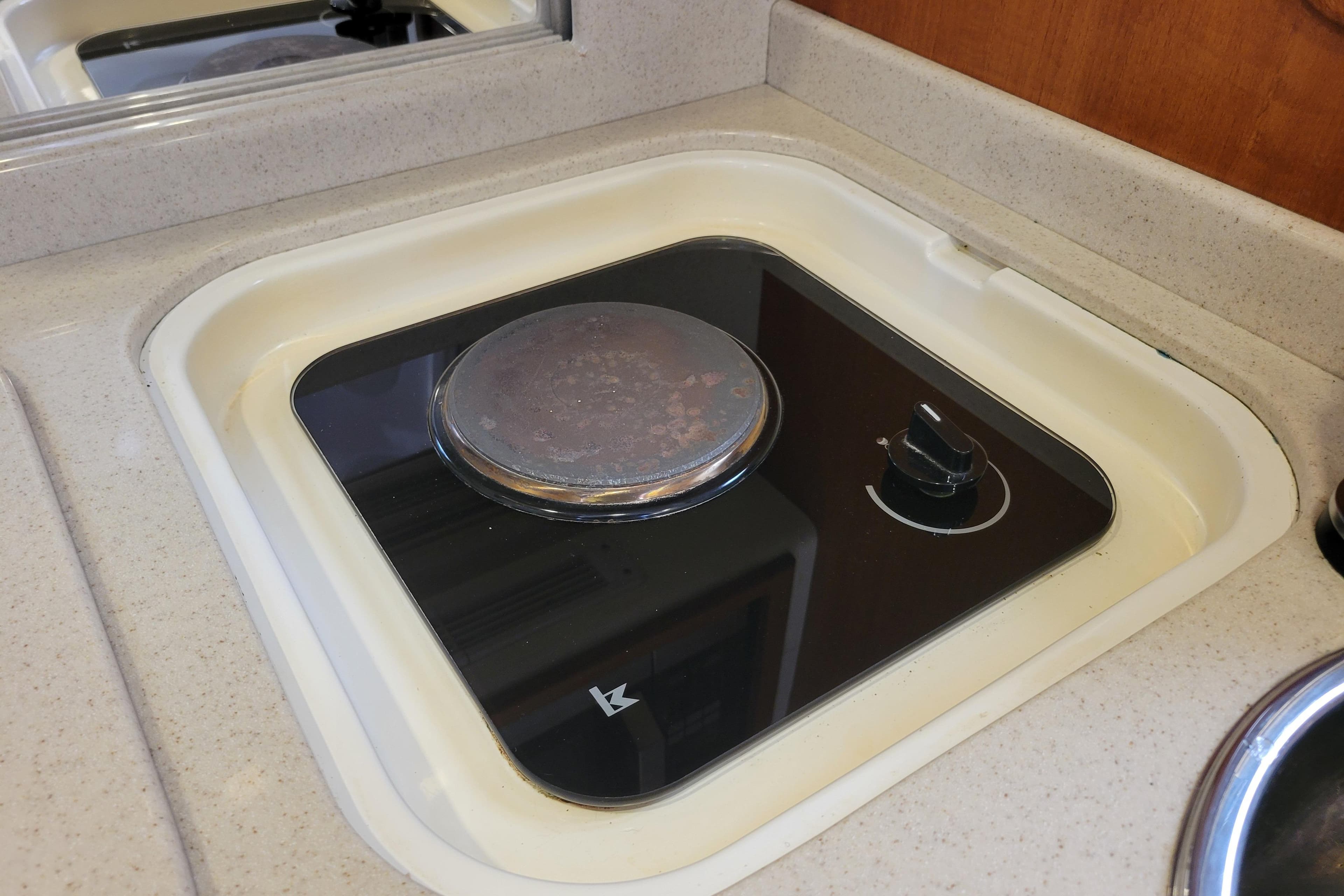 1998 Cabo 31 Express boat stove in compact kitchen area.