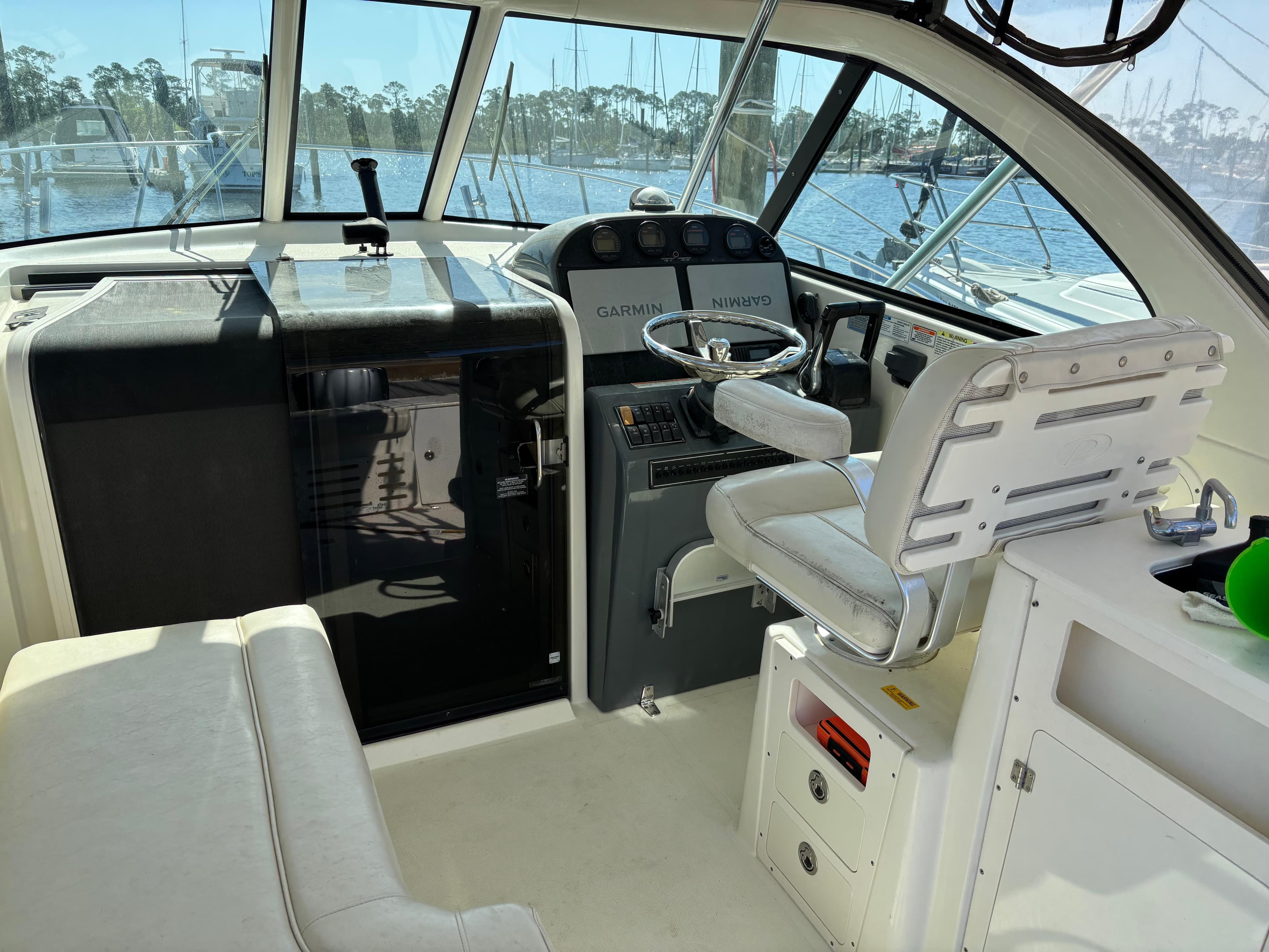 2006 Pursuit 3370 Offshore boat cockpit with steering wheel and navigation equipment.