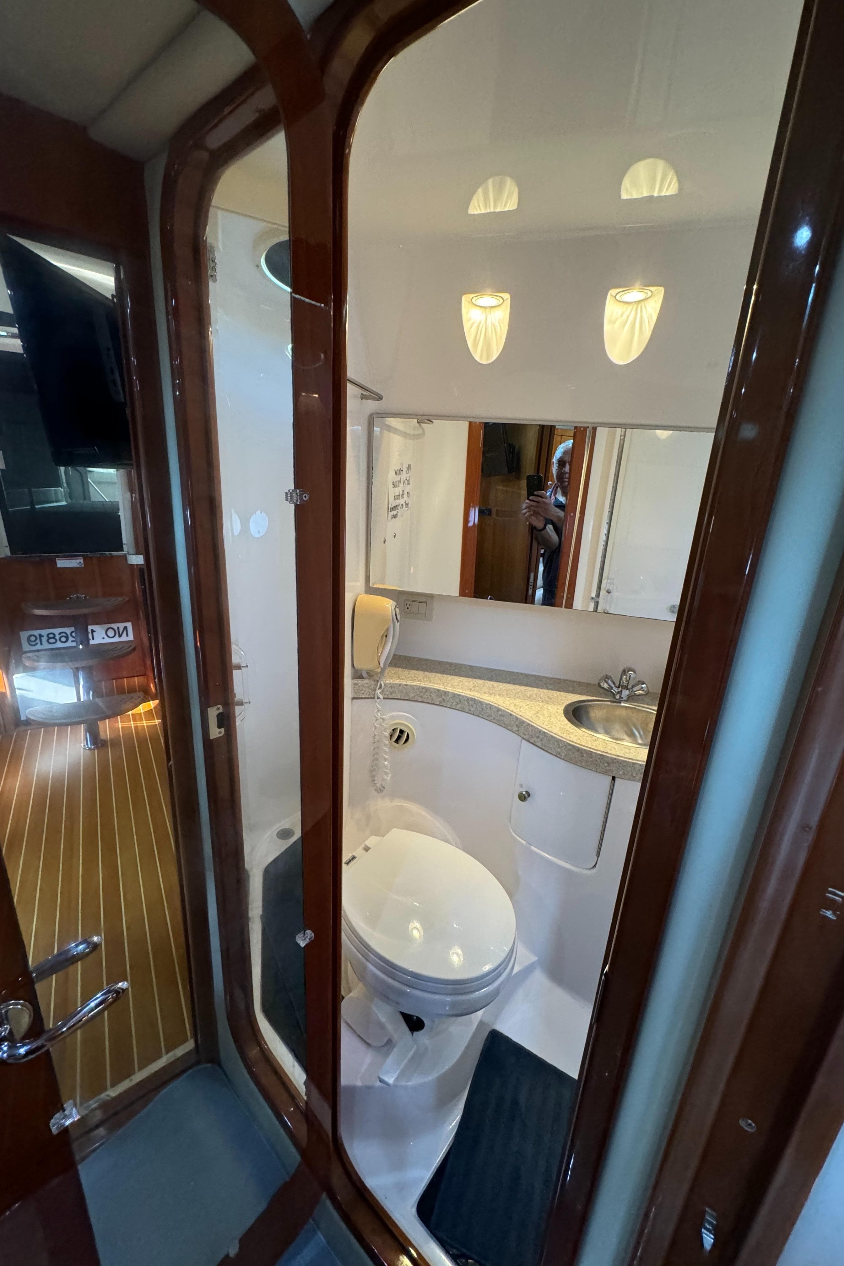 2008 Regal Commodore 4460 yacht bathroom with modern fixtures and elegant wood accents.