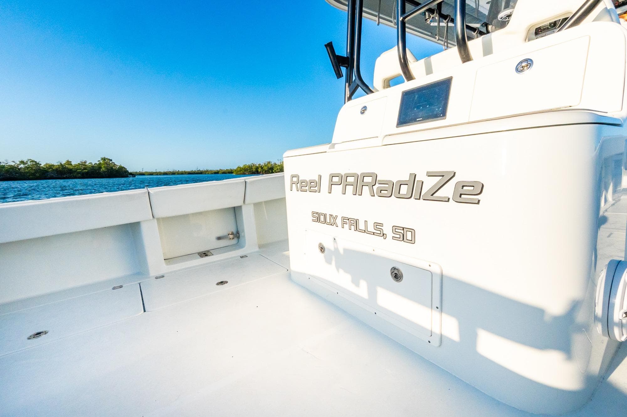 Freeman 42LR boat named "Reel PARadiZe" on water, 2022 model, sunny day.