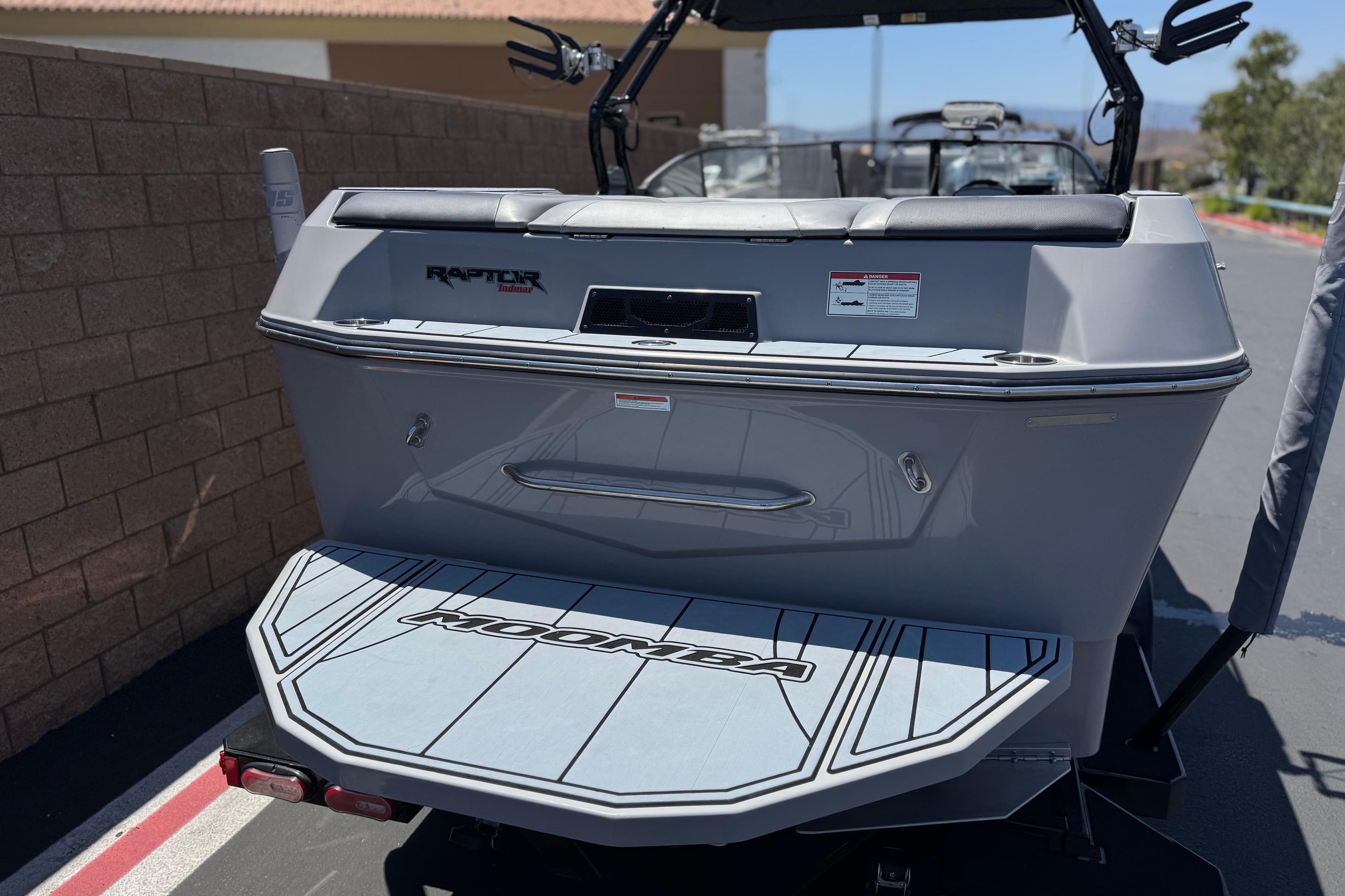 2022 Moomba Max boat rear view with Raptor engine branding, parked outdoors.