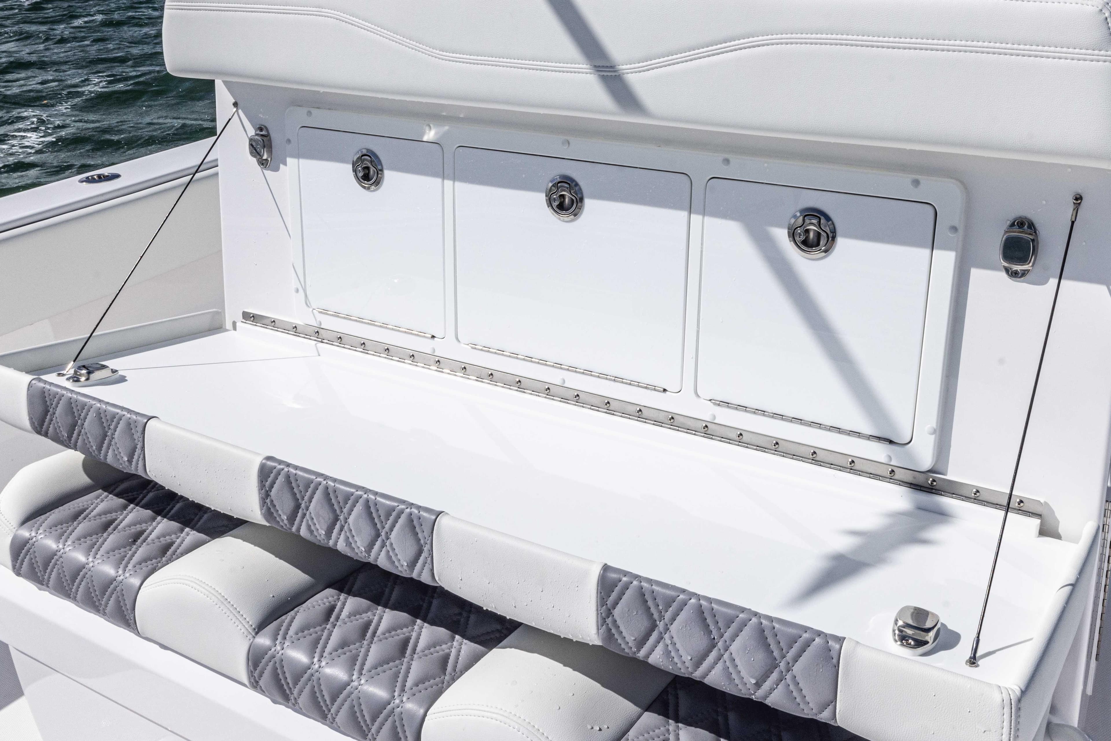 Luxury seating on 2025 Invincible 35 Catamaran with quilted upholstery and storage compartments.